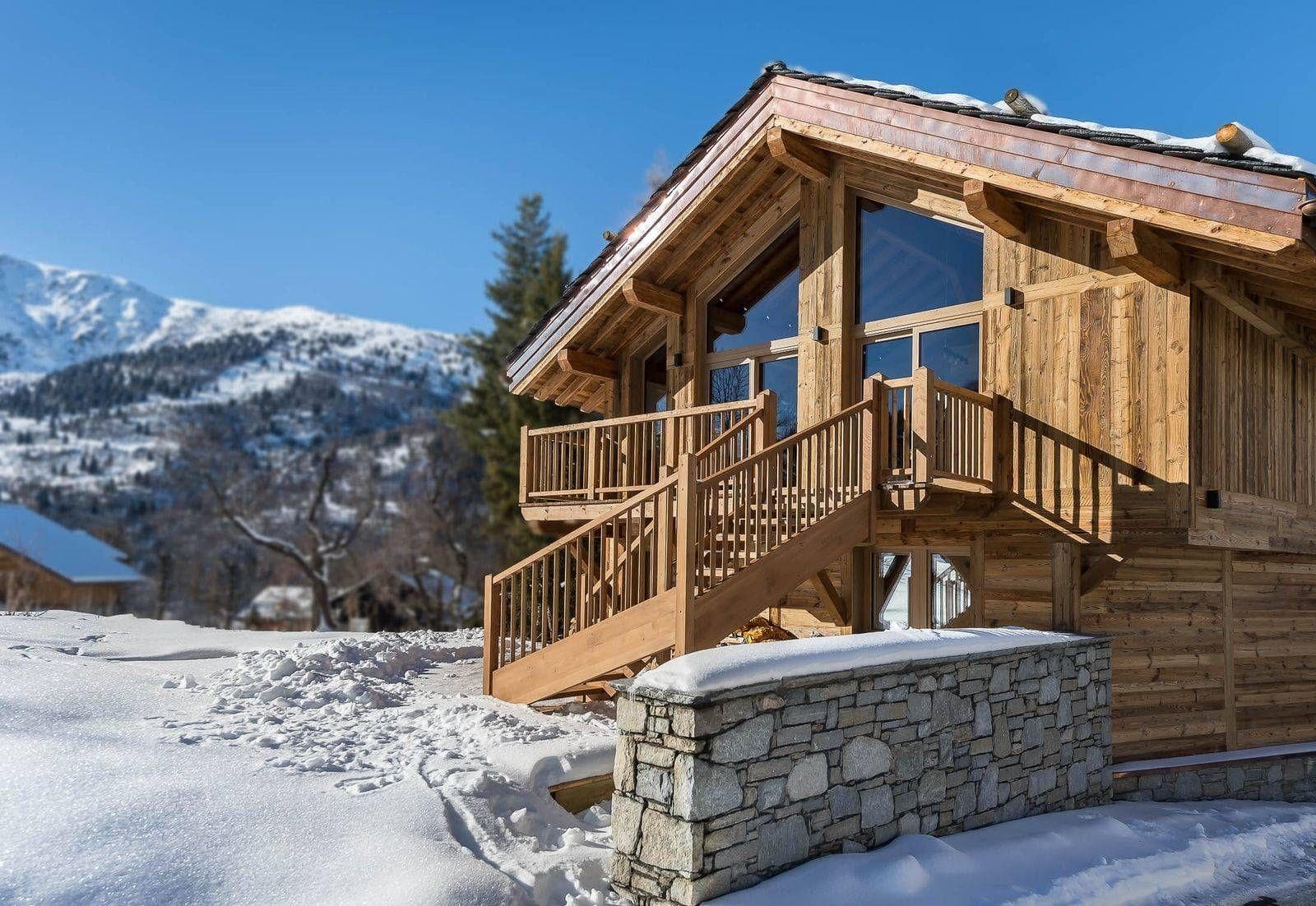 Ski chalet exterior with private balcony and panoramic alpine views