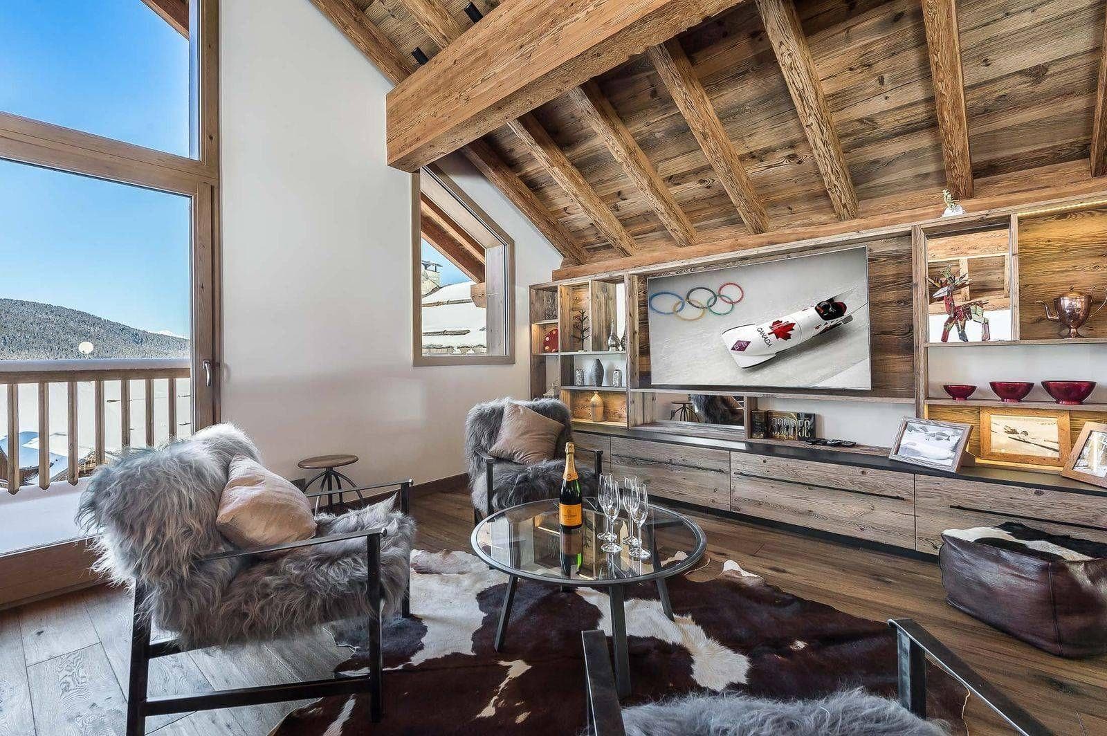 Media room with vaulted timber ceilings and mountain-view balcony