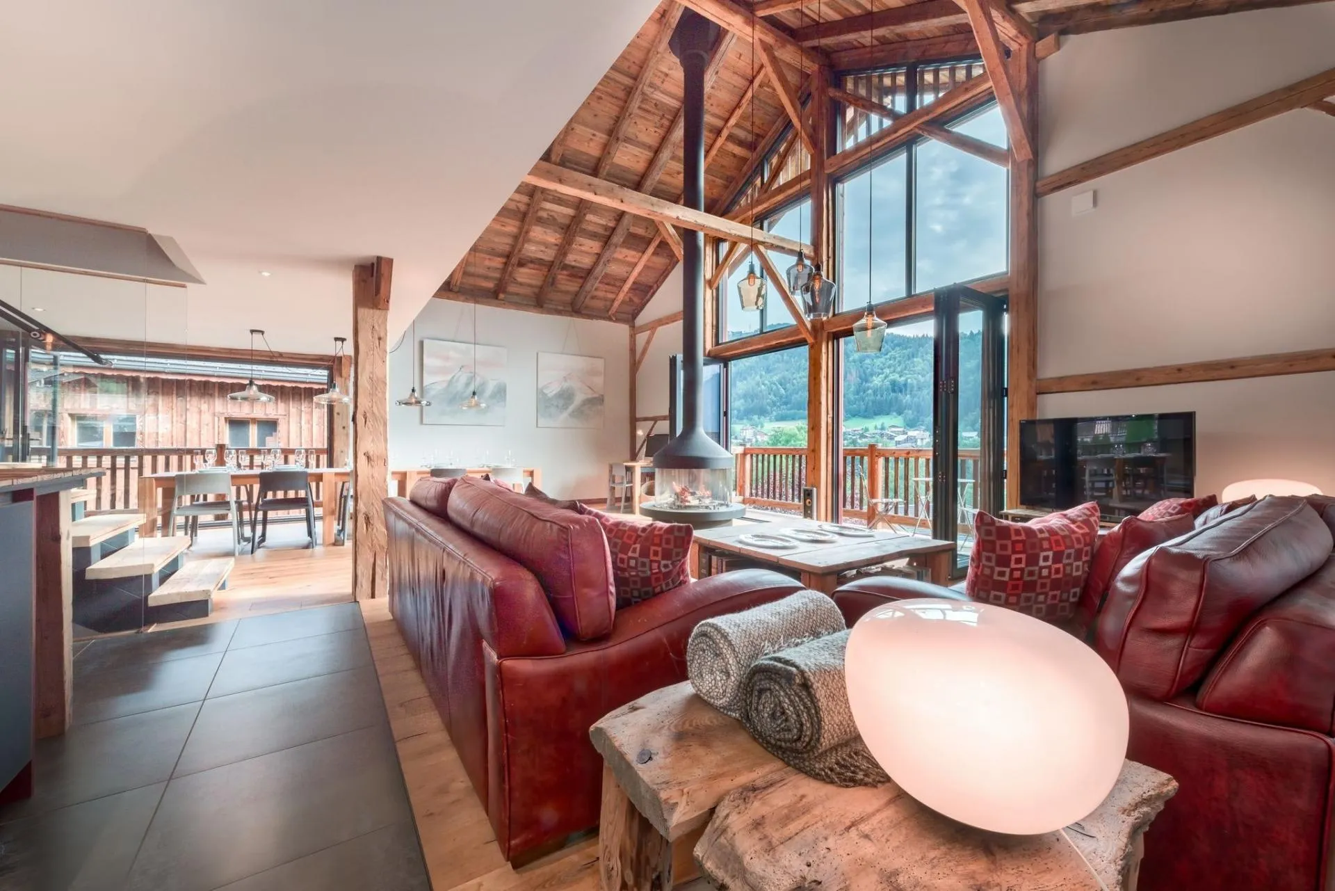 Open living area with a central wood-burning stove and valley views