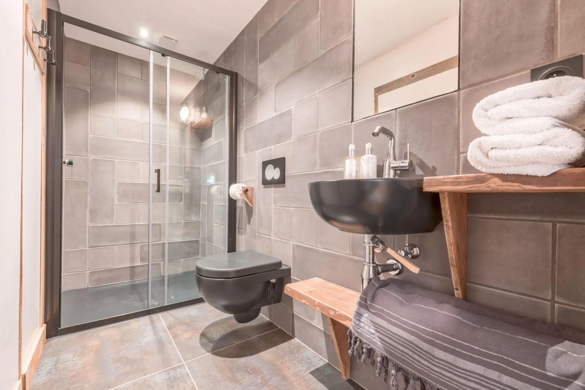 En-suite shower room with a rainfall shower and timber vanity