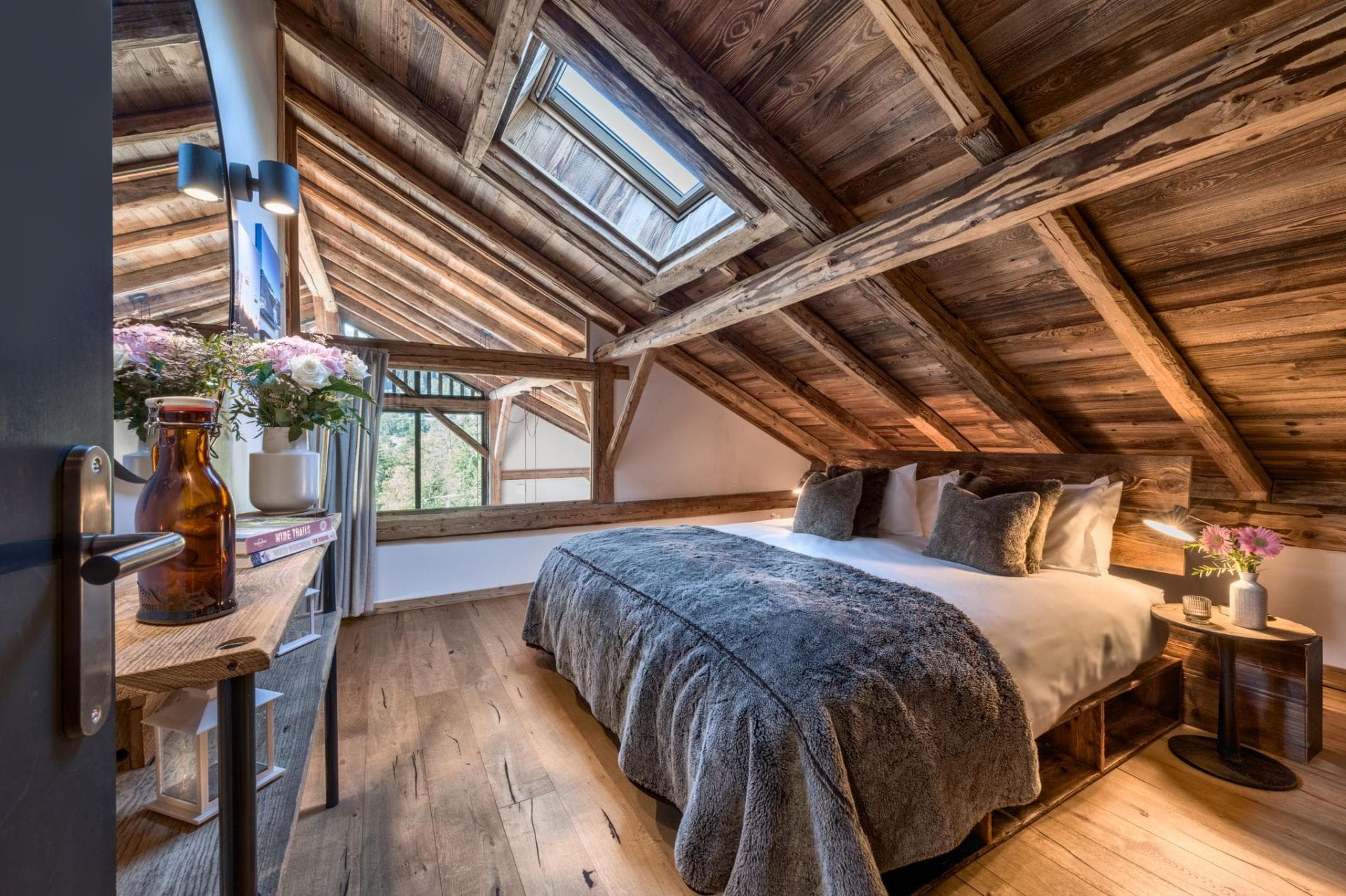 Attic bedroom with king bed, skylight, and exposed timber beams