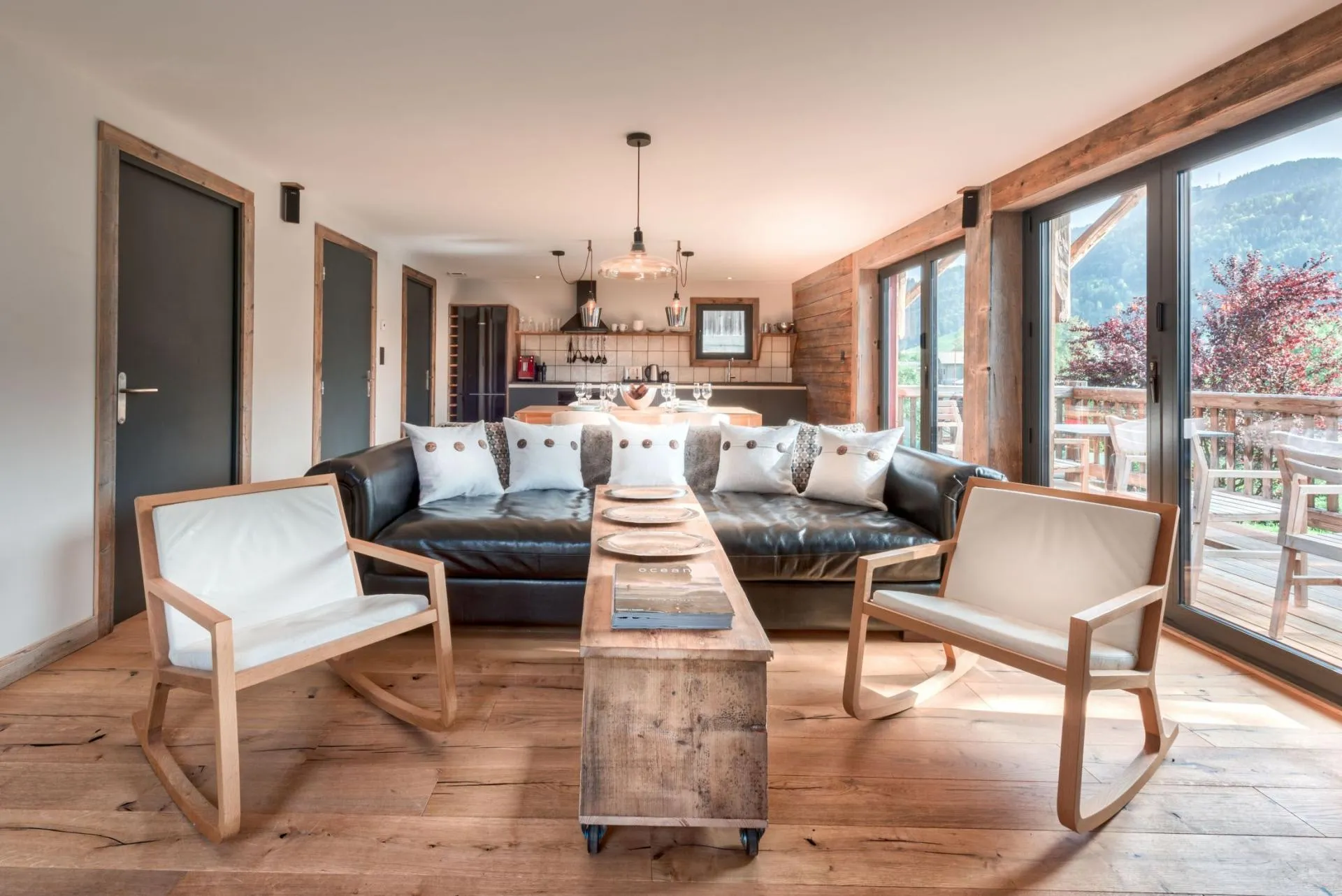Lower-level living area with leather seating and balcony access