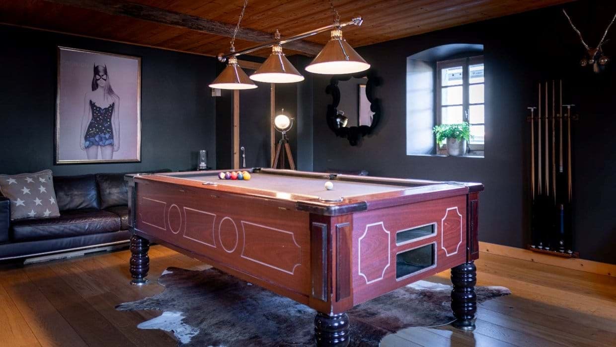 Game room with pool table and leather sofa seating