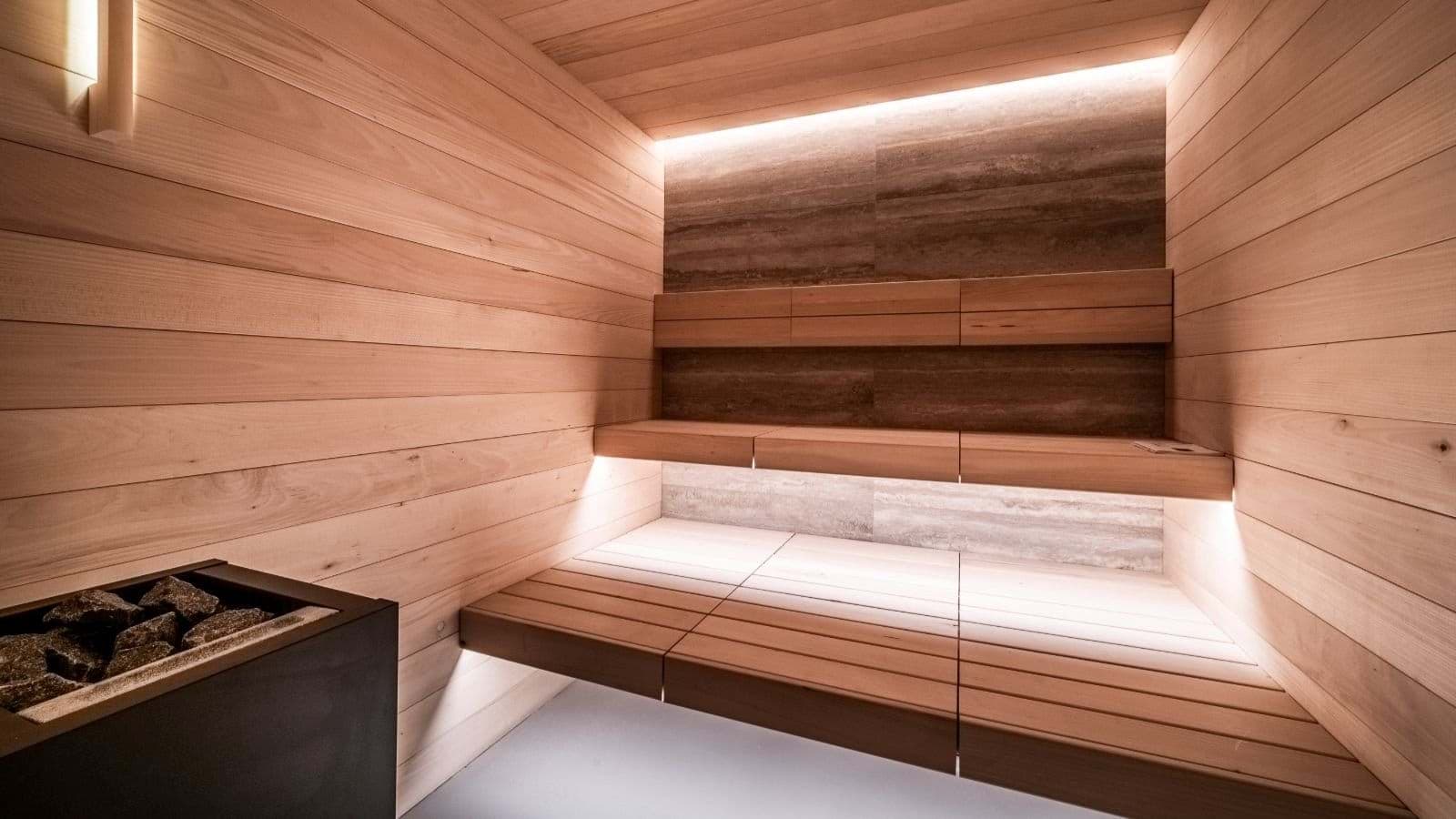 Cedar sauna with tiered seating and stone heater