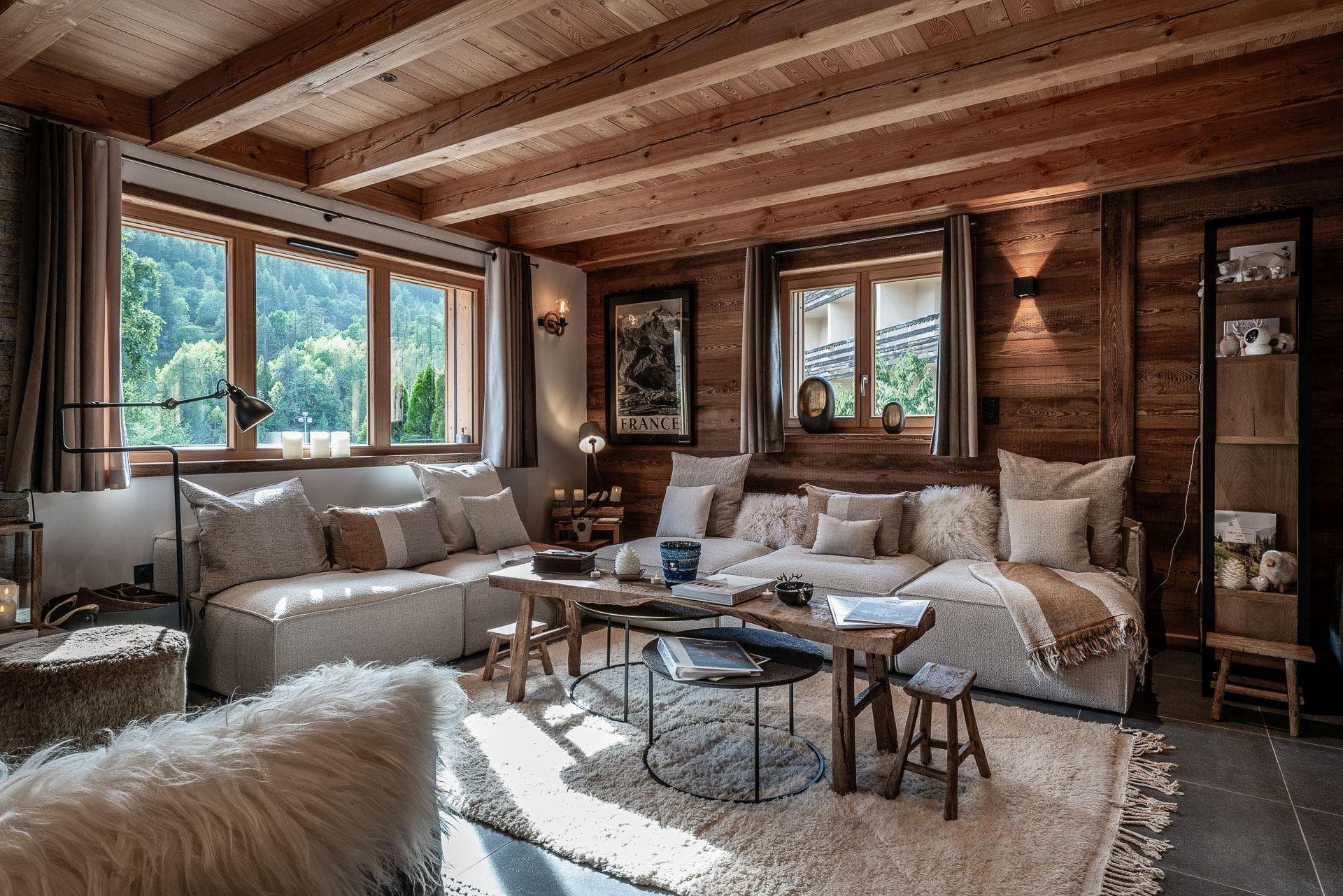 Living area with L-shaped modular sofa and forest views