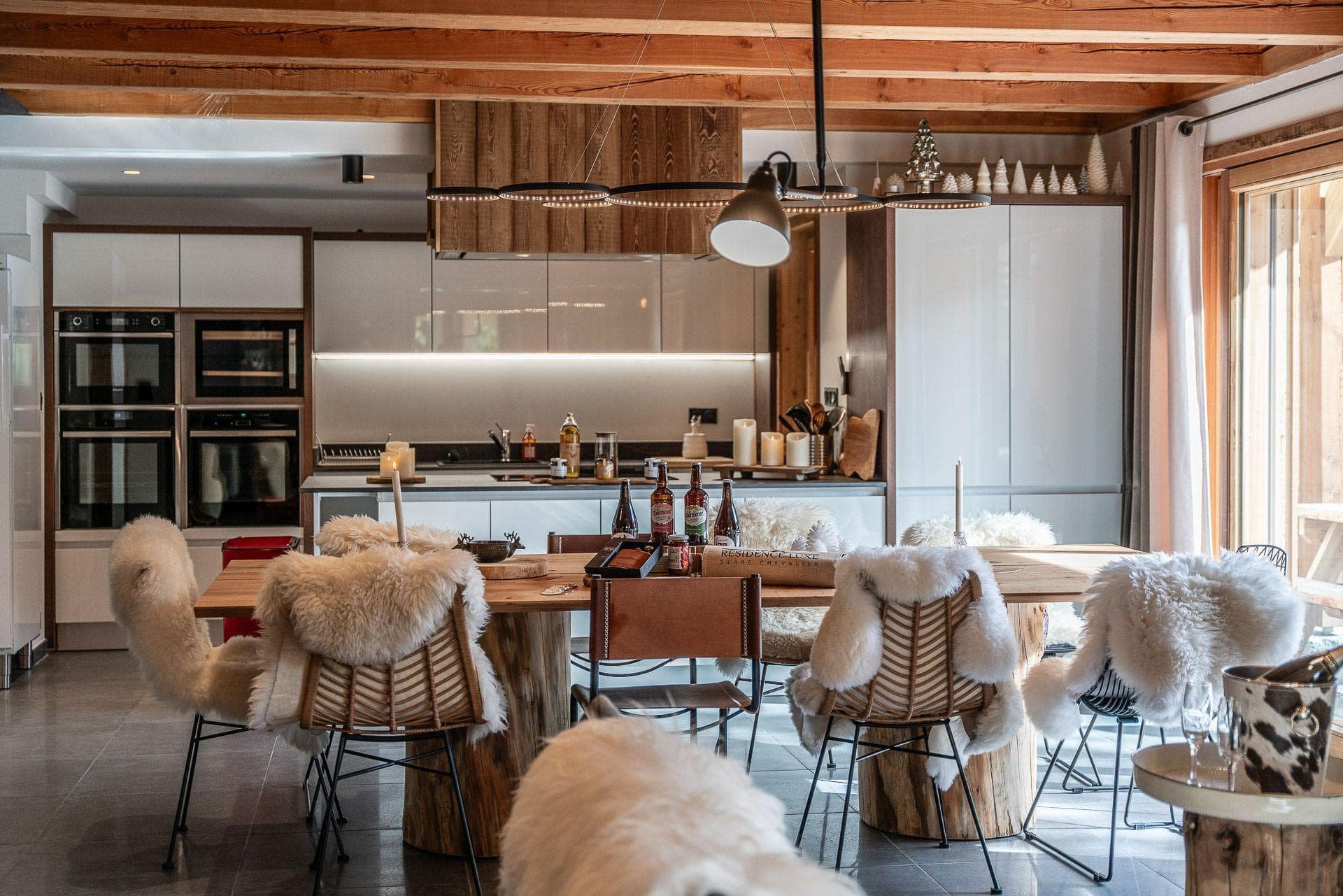 Open-plan dining area and kitchen with double wall ovens