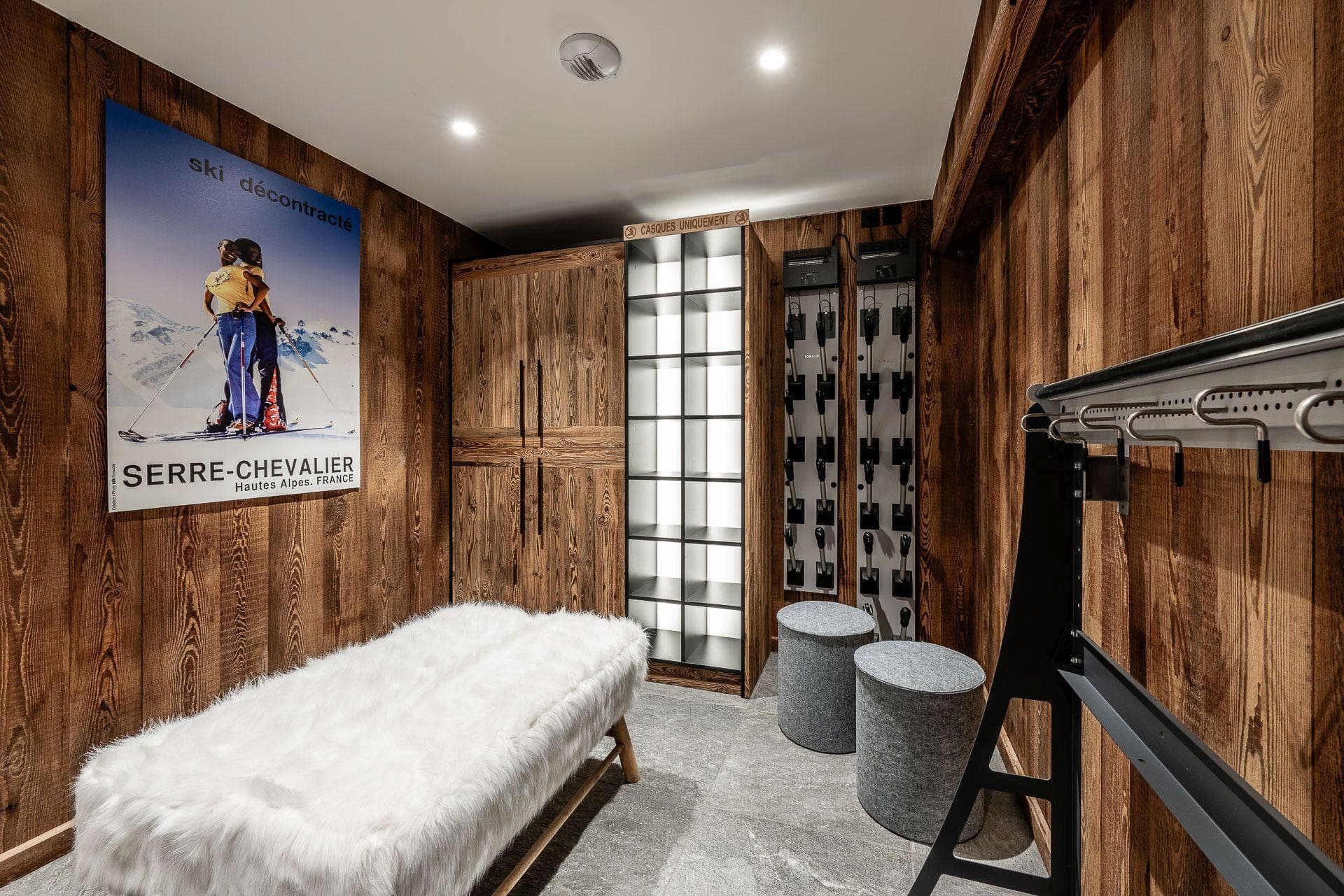 Ski boot room with heated boot dryers and helmet storage cubbies