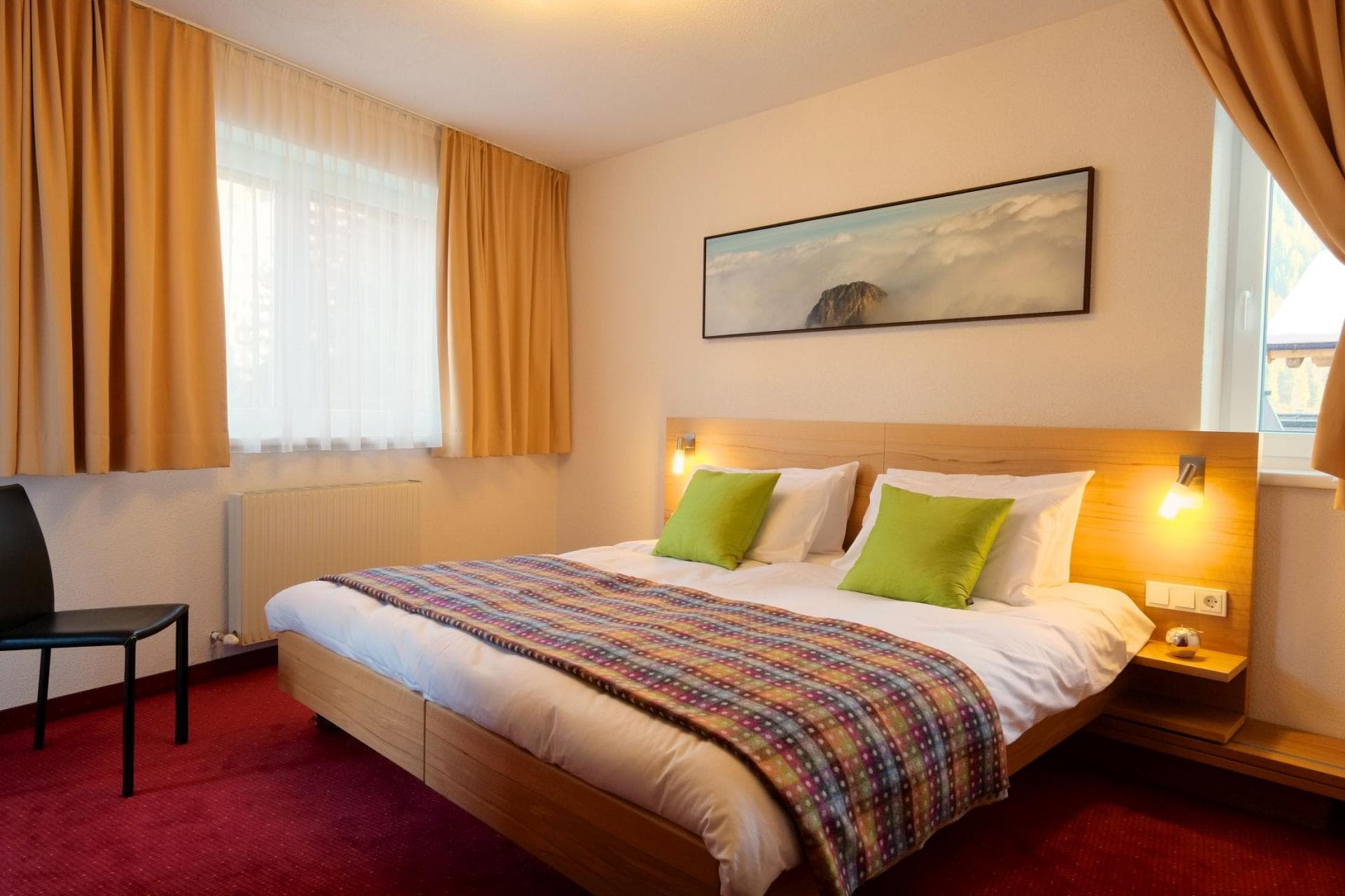 Bedroom with king bed and integrated bedside reading lamps