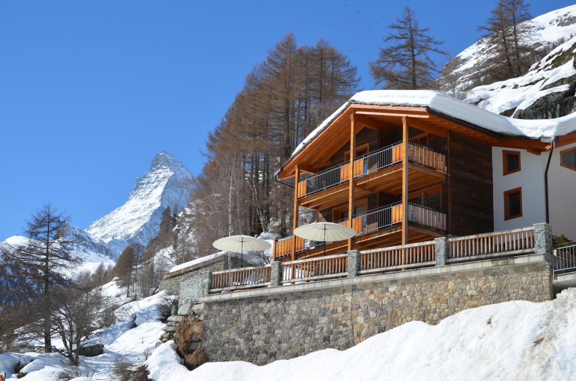 Chalet exterior with multi-level private balconies and Matterhorn peak views