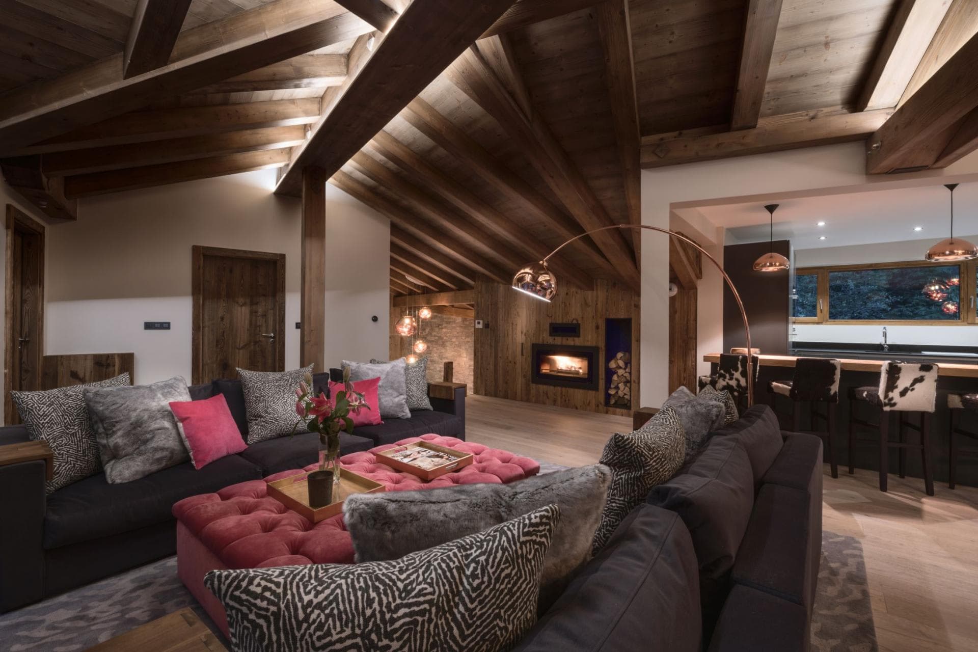 Living area with vaulted timber ceilings and wood-burning fireplace