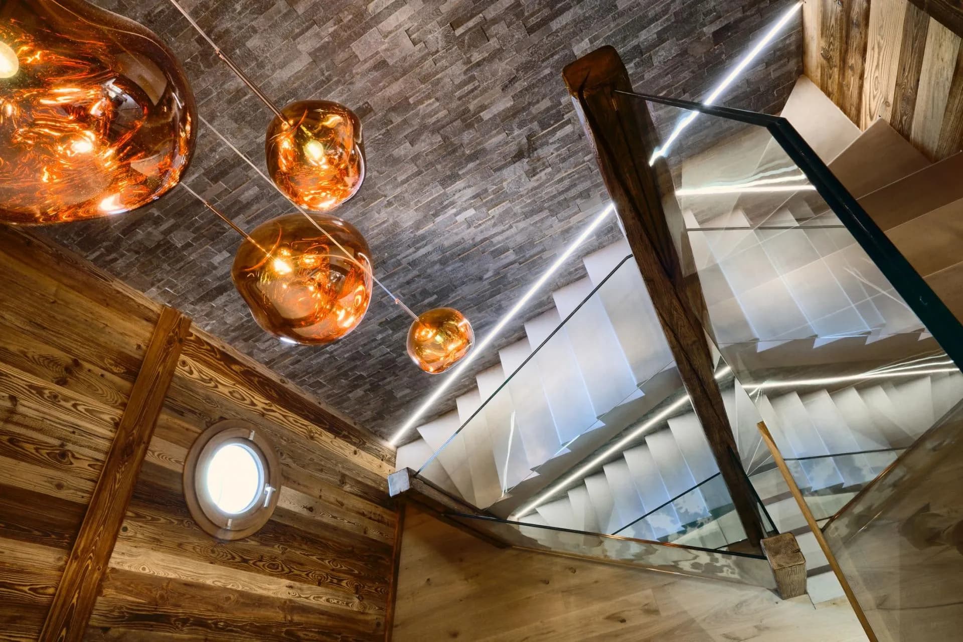 Modern staircase with glass balustrades and integrated lighting