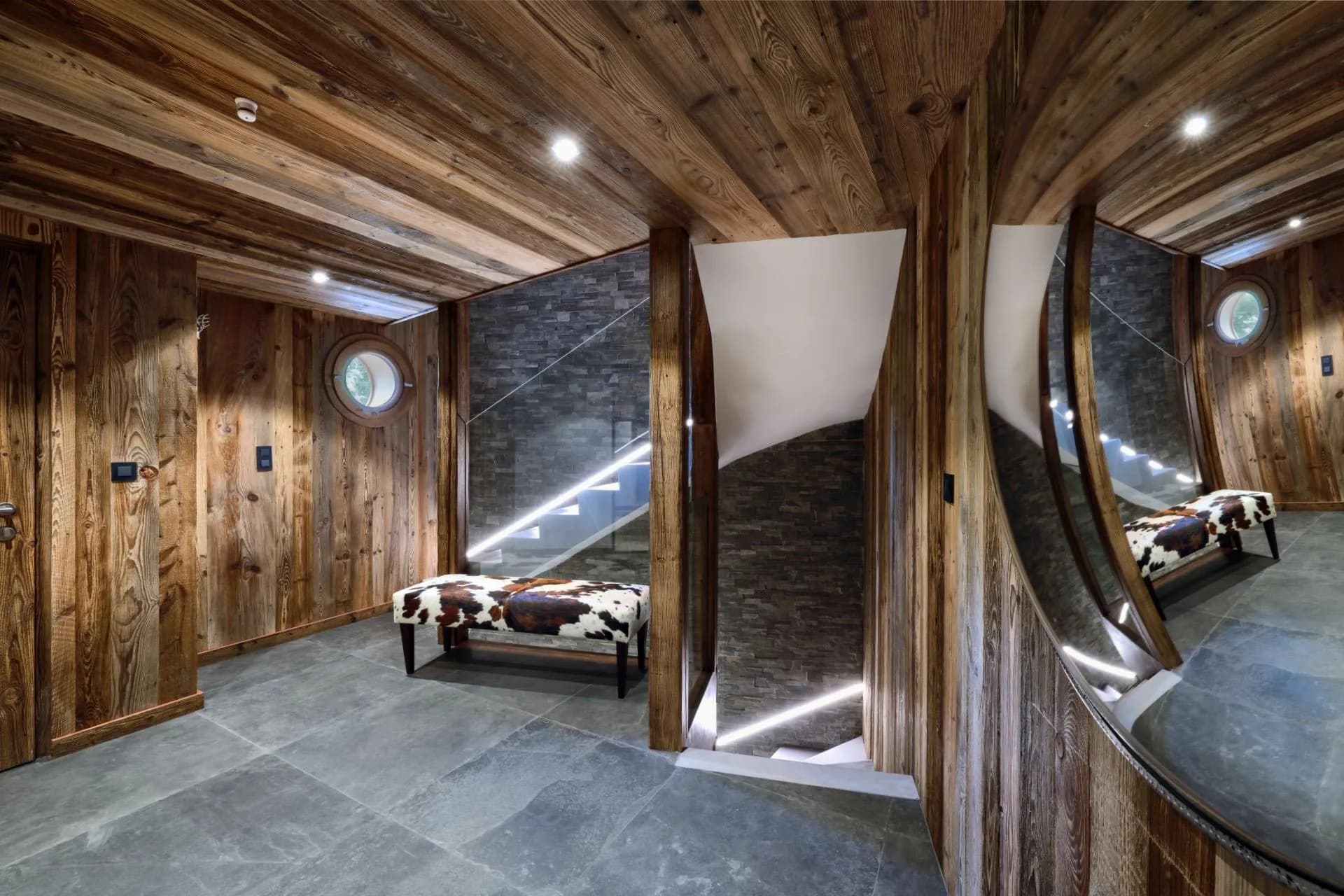 Timber-lined staircase connecting the chalet's entertaining levels