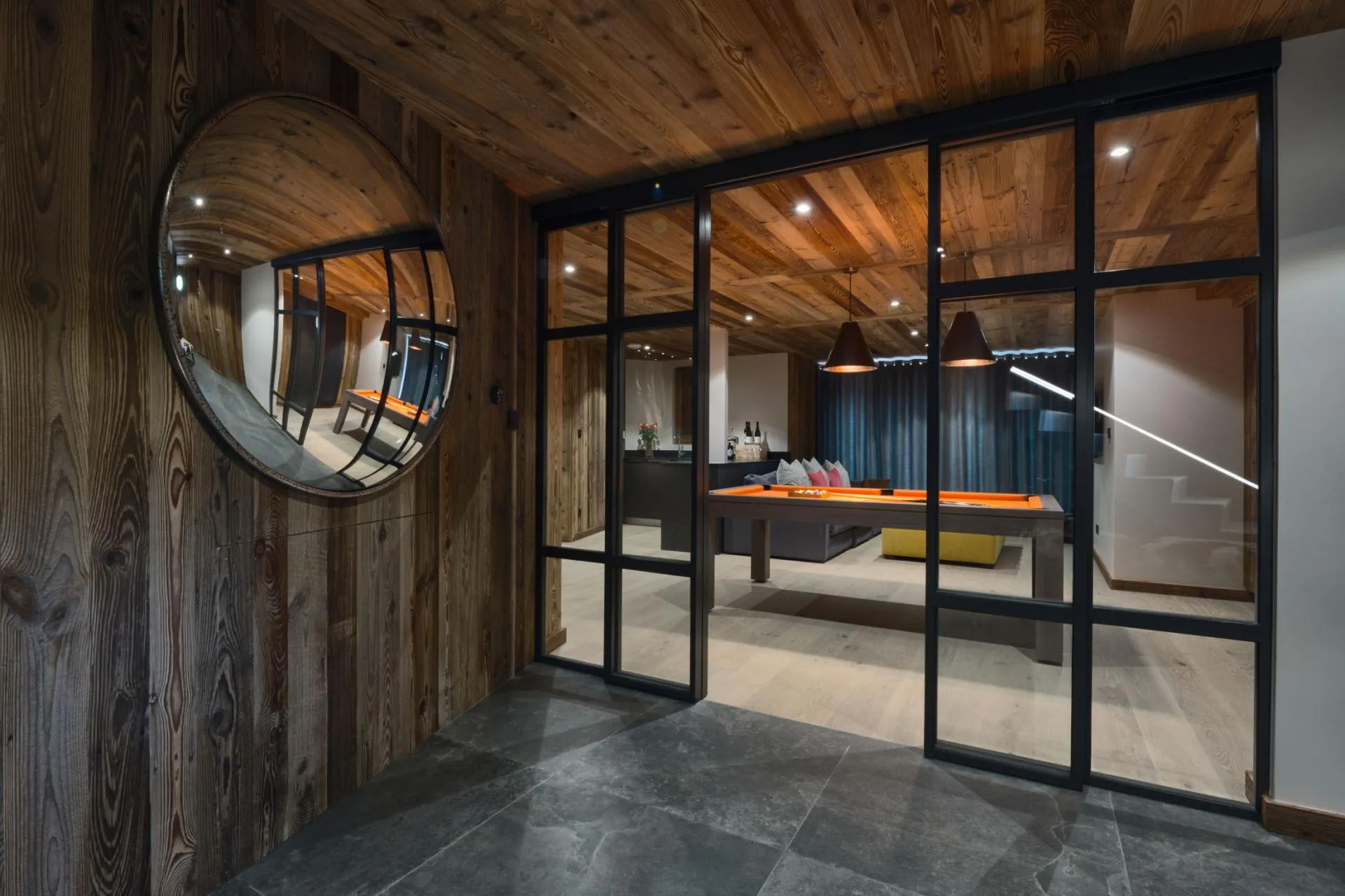 Entrance-level lounge with pool table, TV area and kitchenette