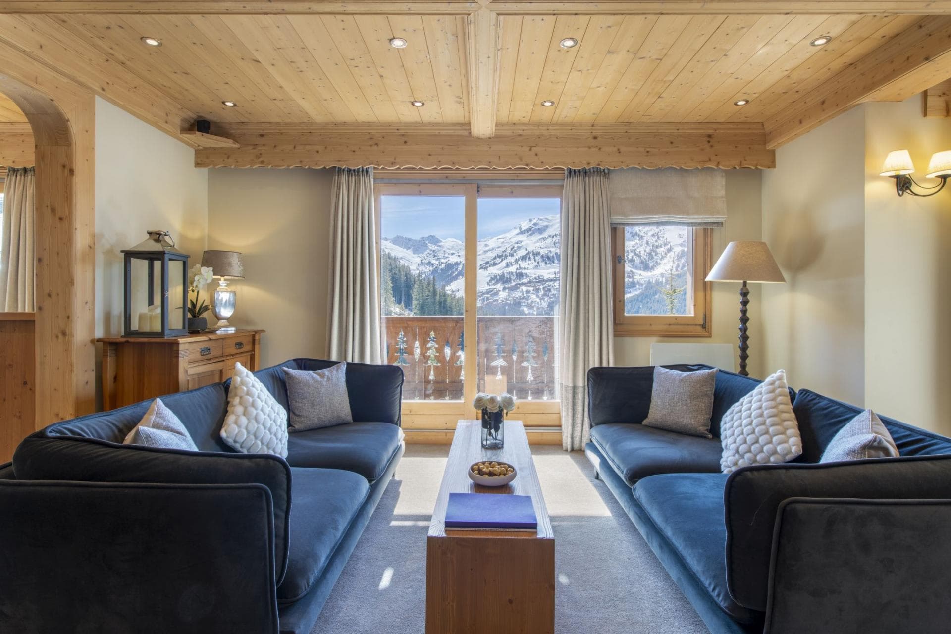 Living room with dual sofas and balcony access to mountain views