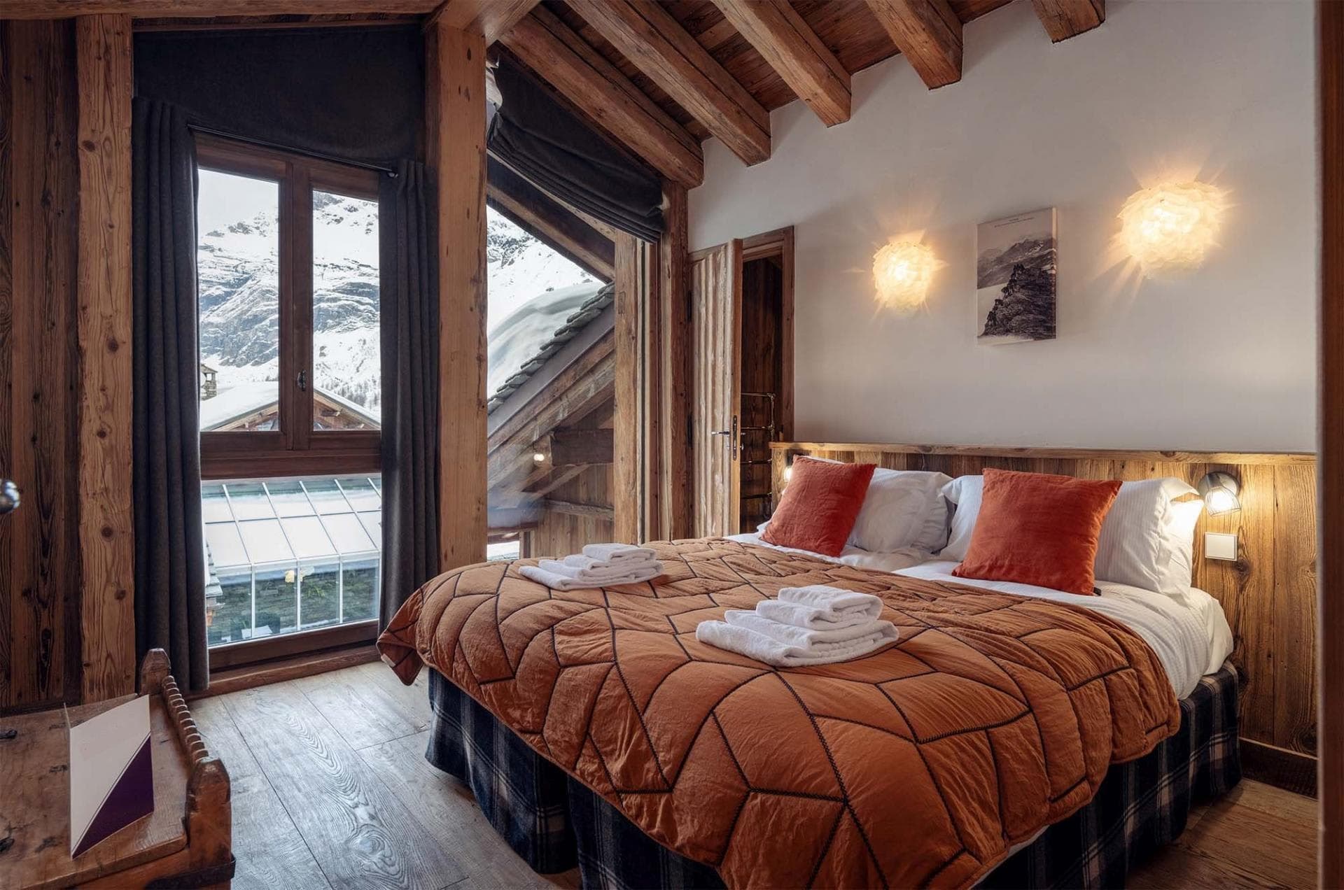 Guest bedroom with king bed and snow-capped mountain views