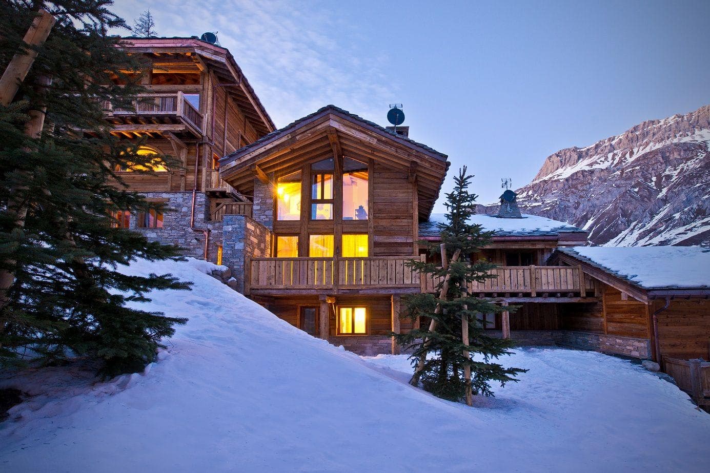 Ski-in/ski-out chalet exterior with multi-level timber balconies and mountain views