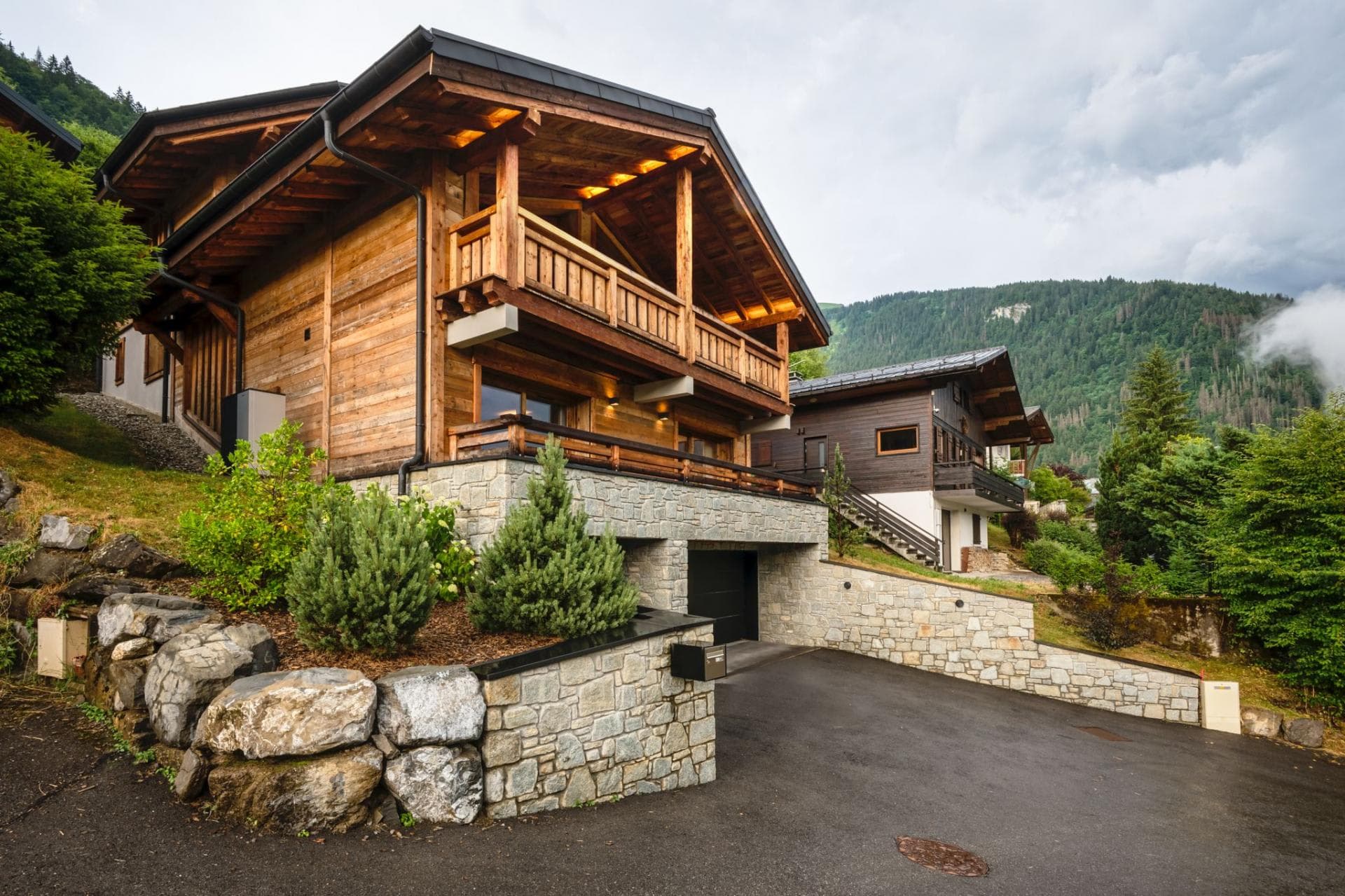 Chalet exterior with two-car garage and wrap-around balconies