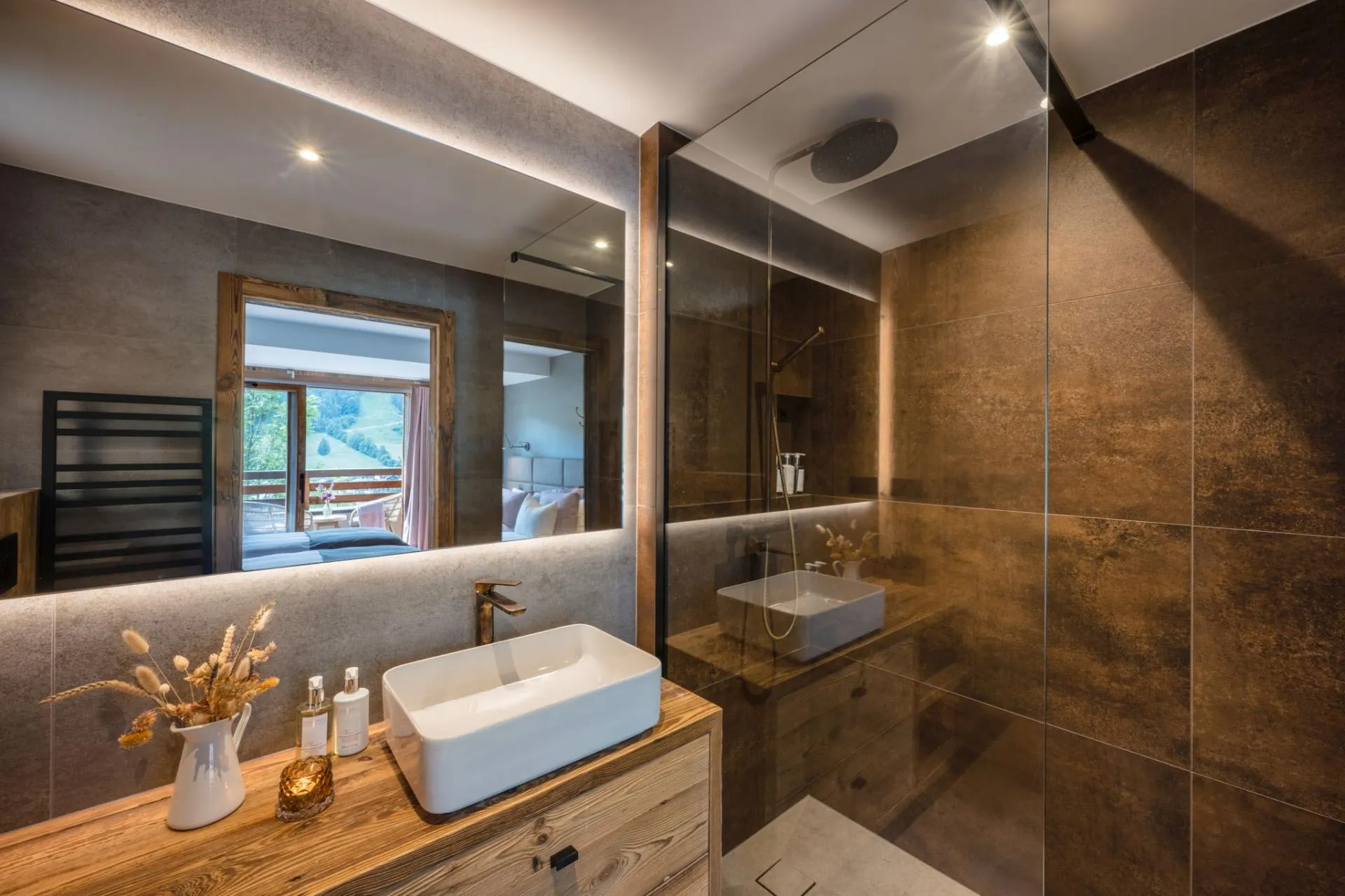 Bathroom with an oval bath, twin basins and walk-in shower