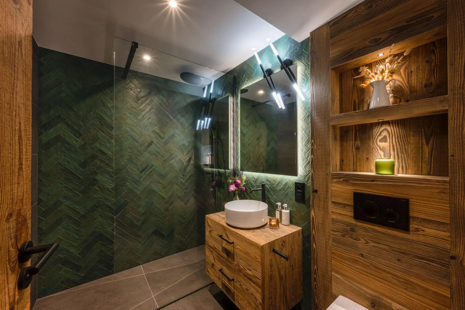 Bathroom with an oval bath beneath a sloping timber ceiling