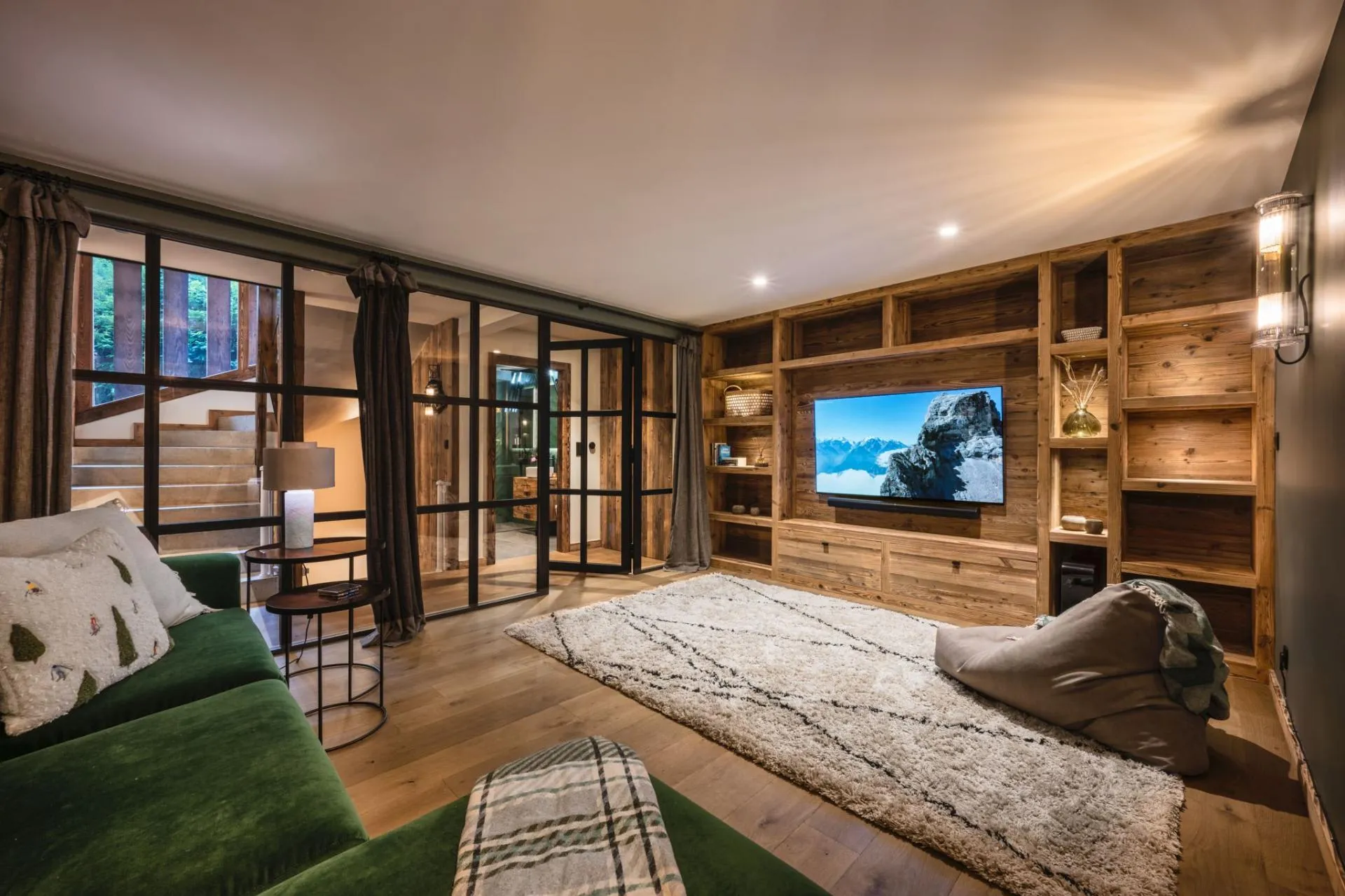 TV room with corner sofa and timber-panelled walls