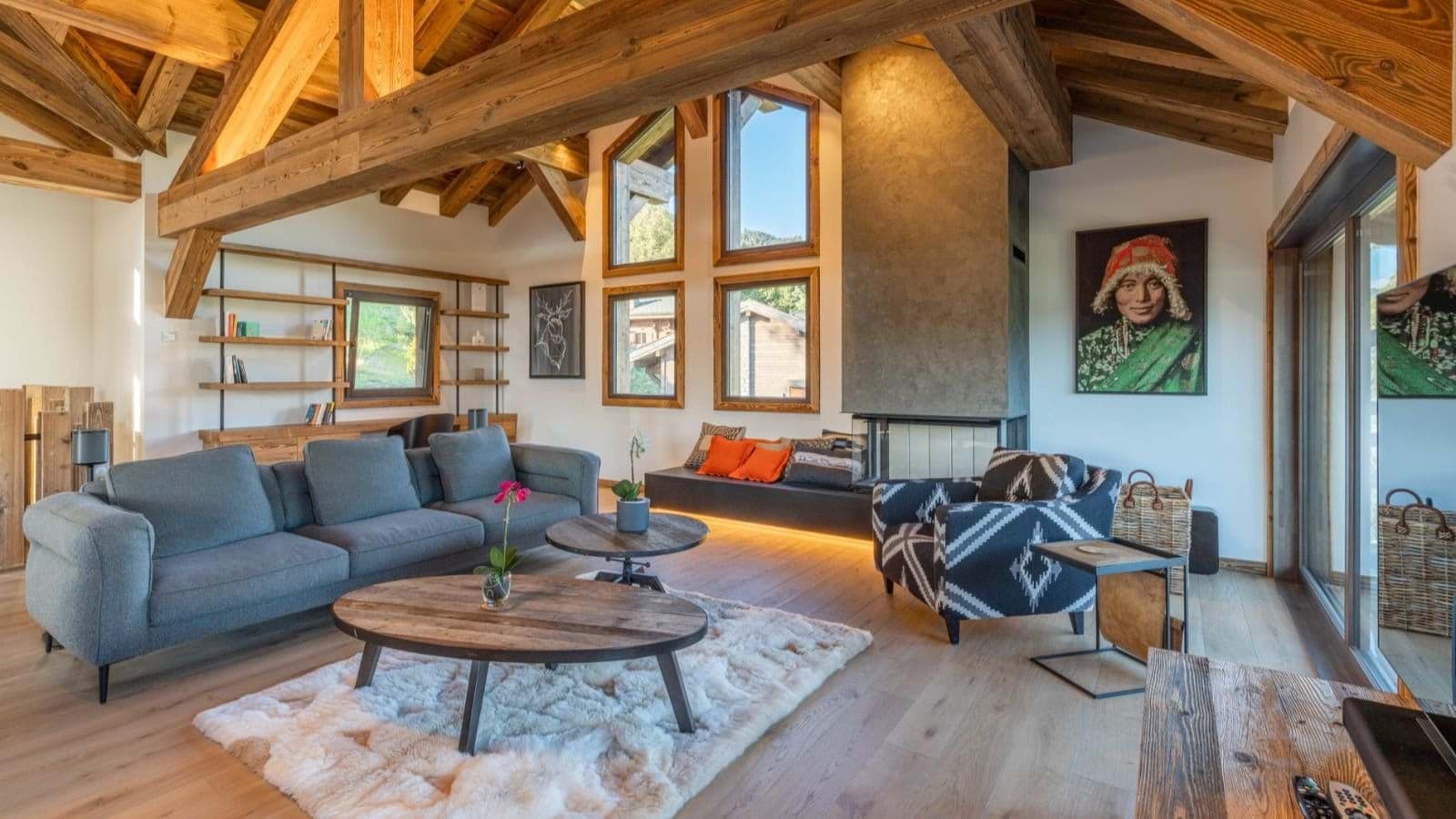 Living area with wood-burning fireplace and exposed timber beams