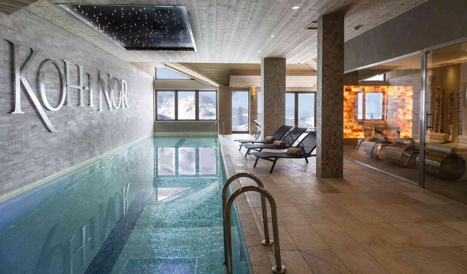 Indoor lap pool with mountain views and adjacent Himalayan salt sauna