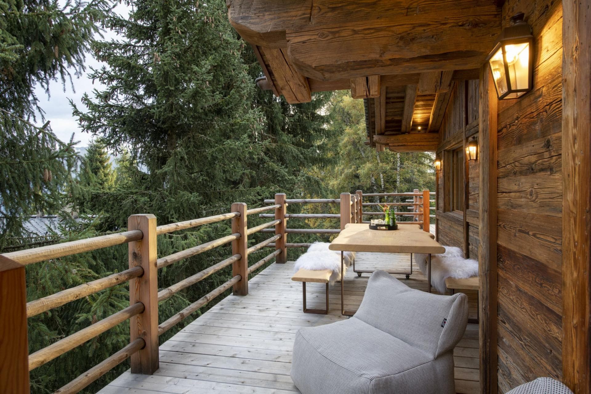 Covered timber balcony with forest views and dining for 6