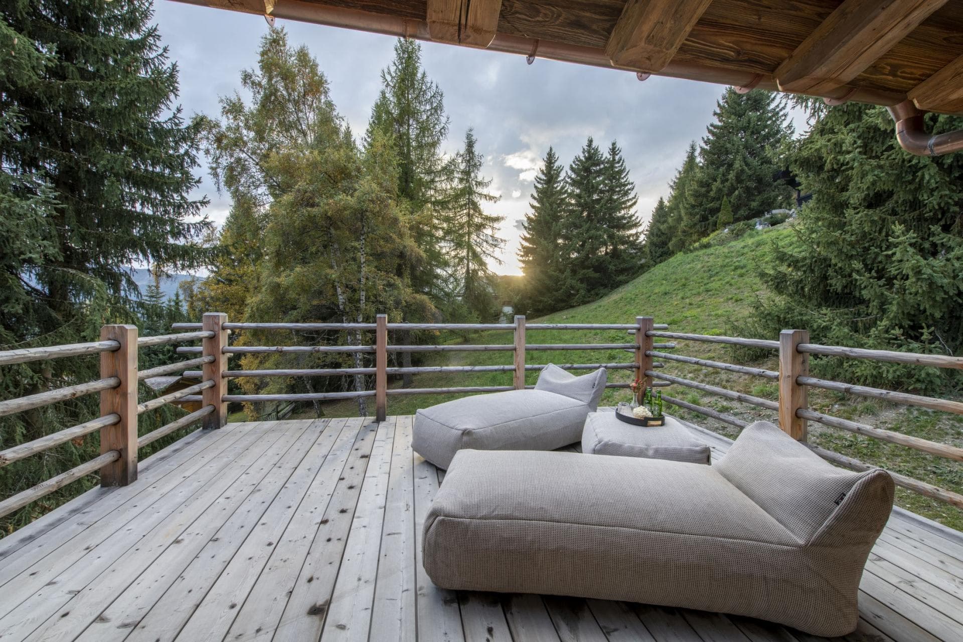 Timber sun deck with bean bag loungers and forest views