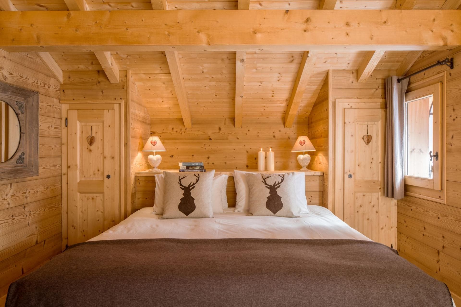 Wood-paneled bedroom with king bed and built-in closet storage