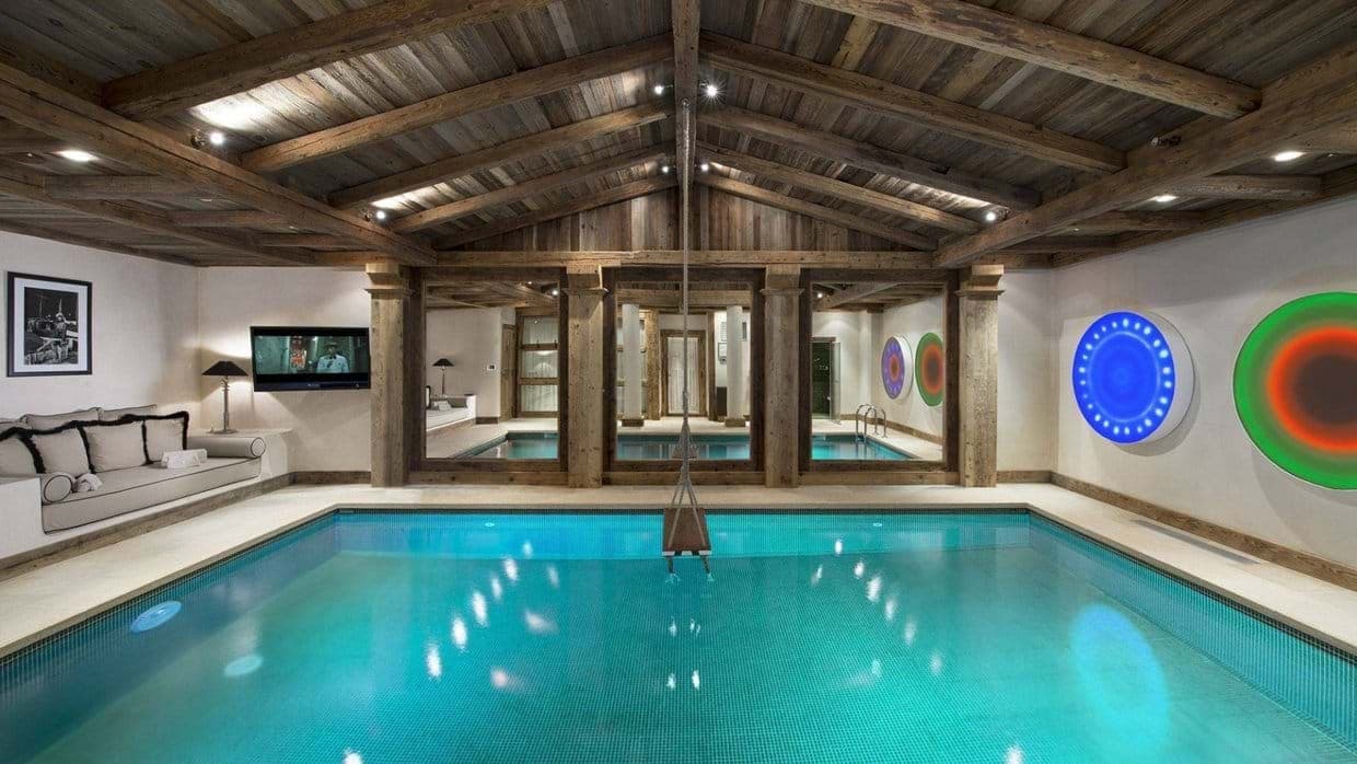 Indoor pool with reclaimed wood ceiling and built-in lounge seating