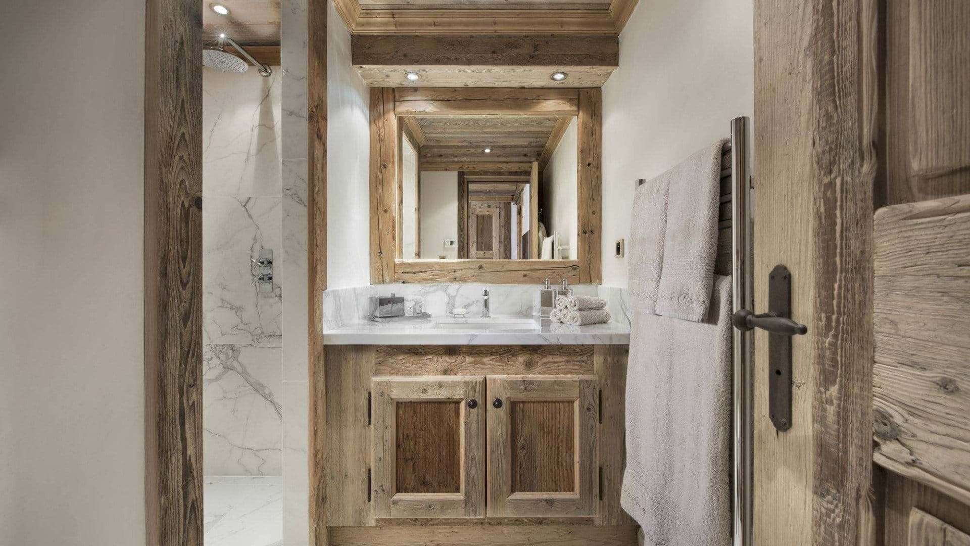 Bathroom featuring marble walk-in shower and heated towel rail