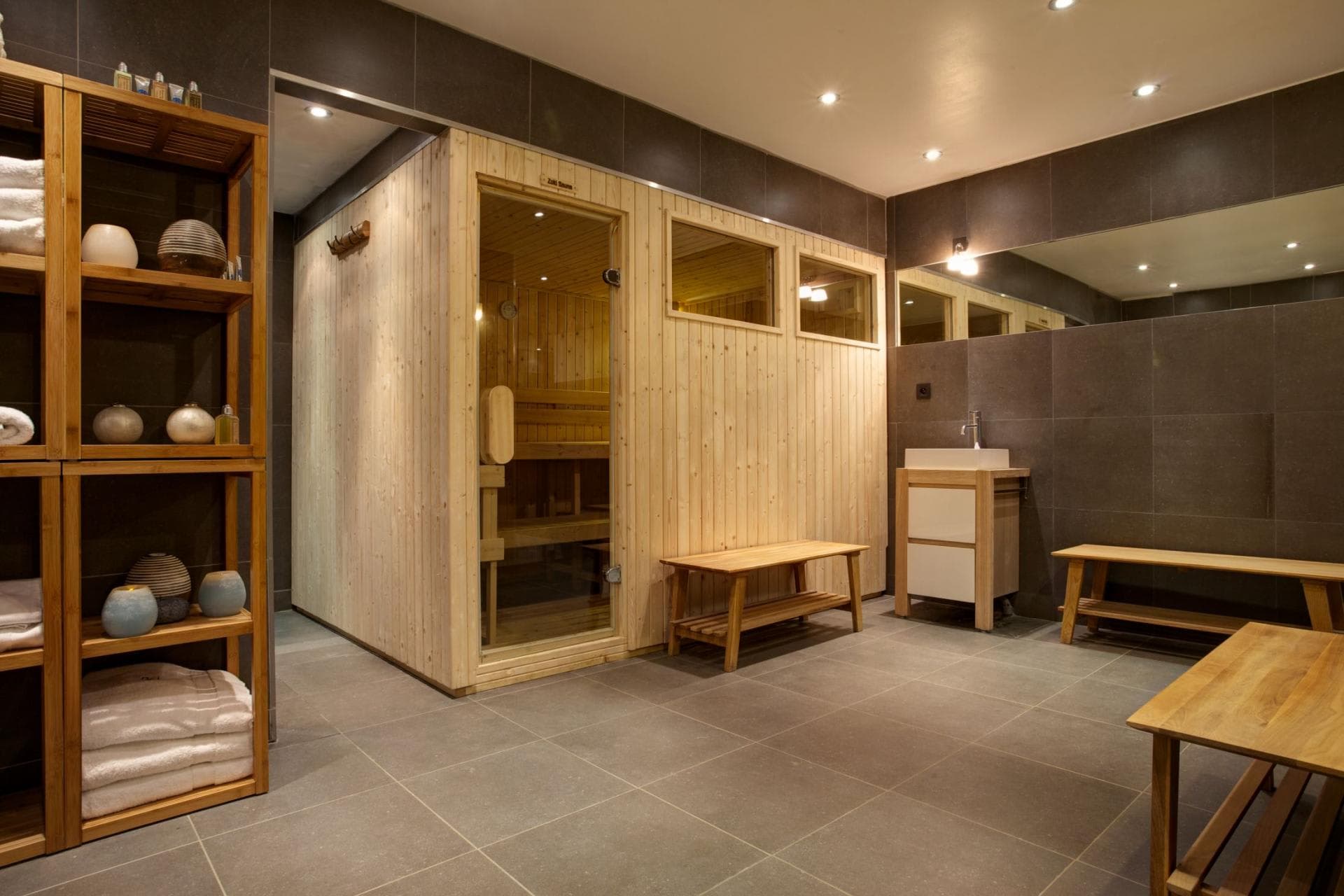 Private spa area with wood sauna, changing benches, and fresh towels