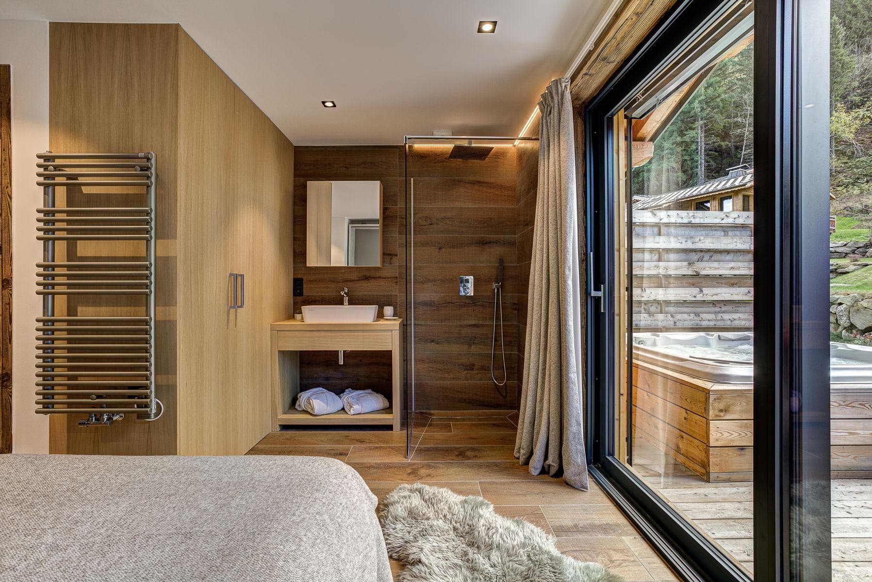 Ensuite with rainfall shower, heated towel rack, and direct terrace access