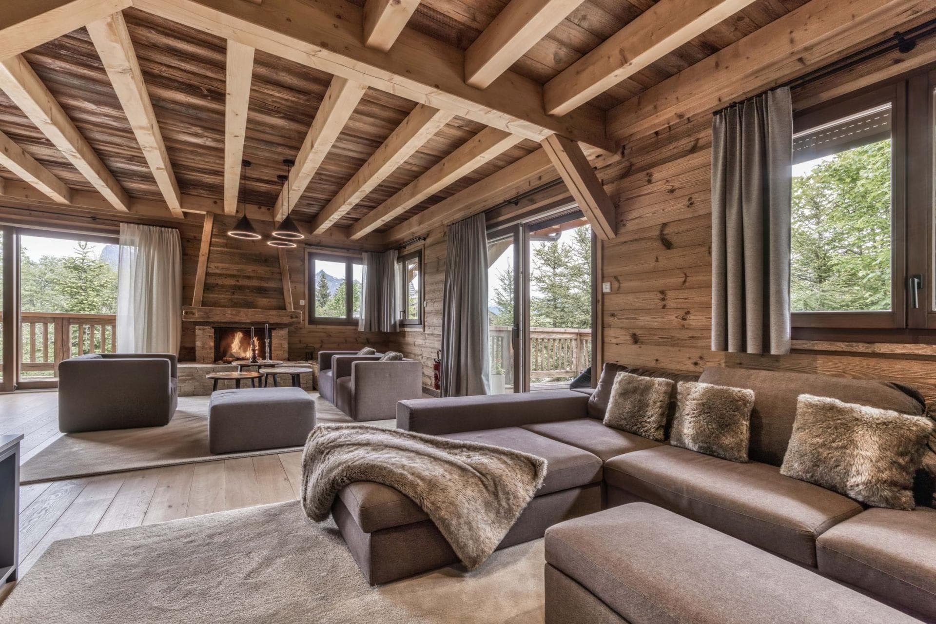 Living area with wood-burning fireplace and balcony access