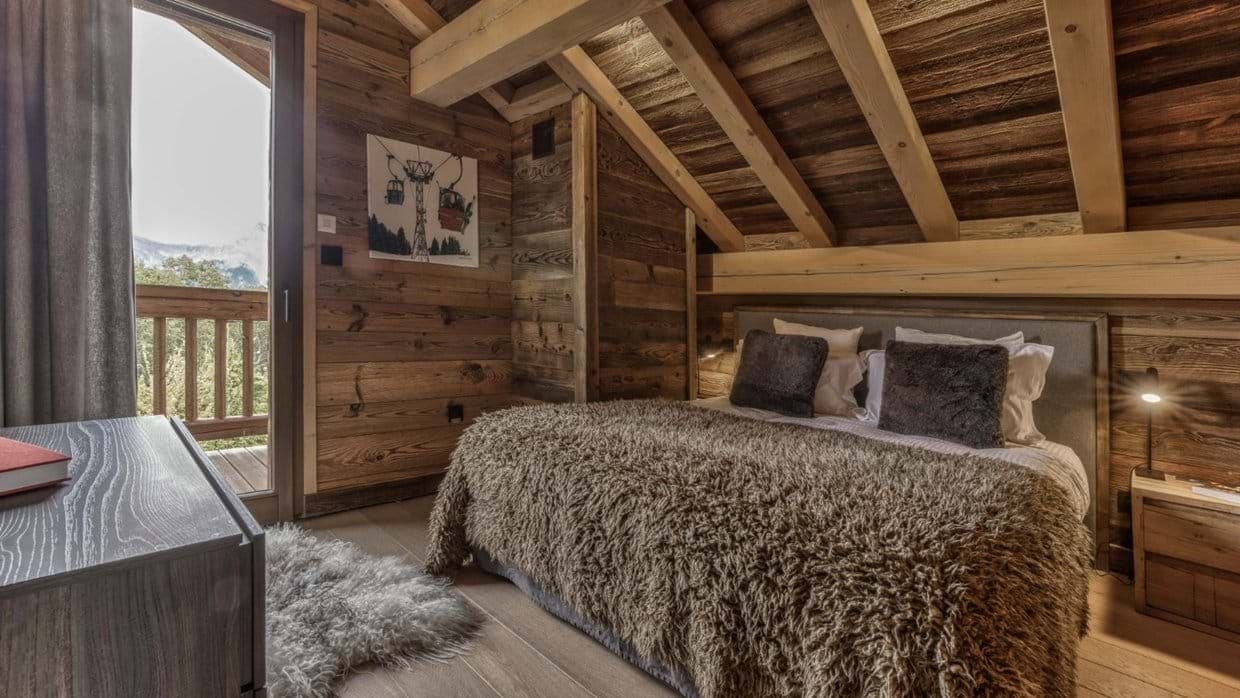 Bedroom with king bed and private balcony access; mountain views