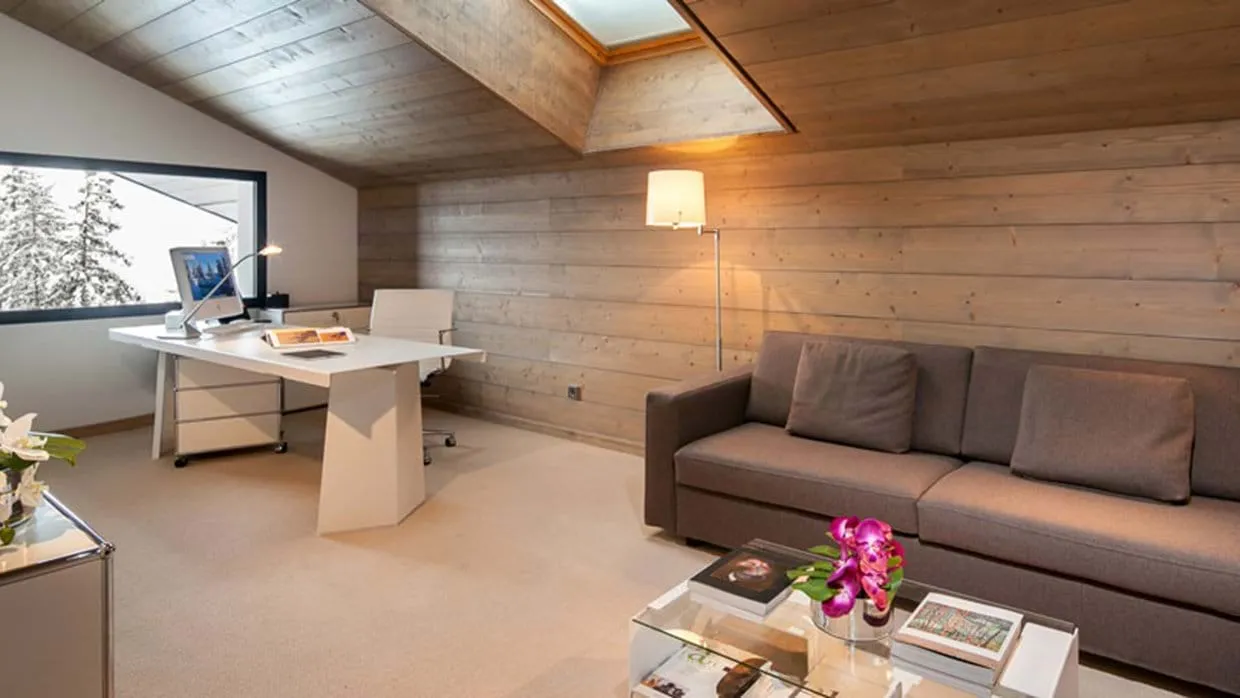 Office and lounge area with dedicated desk and skylight