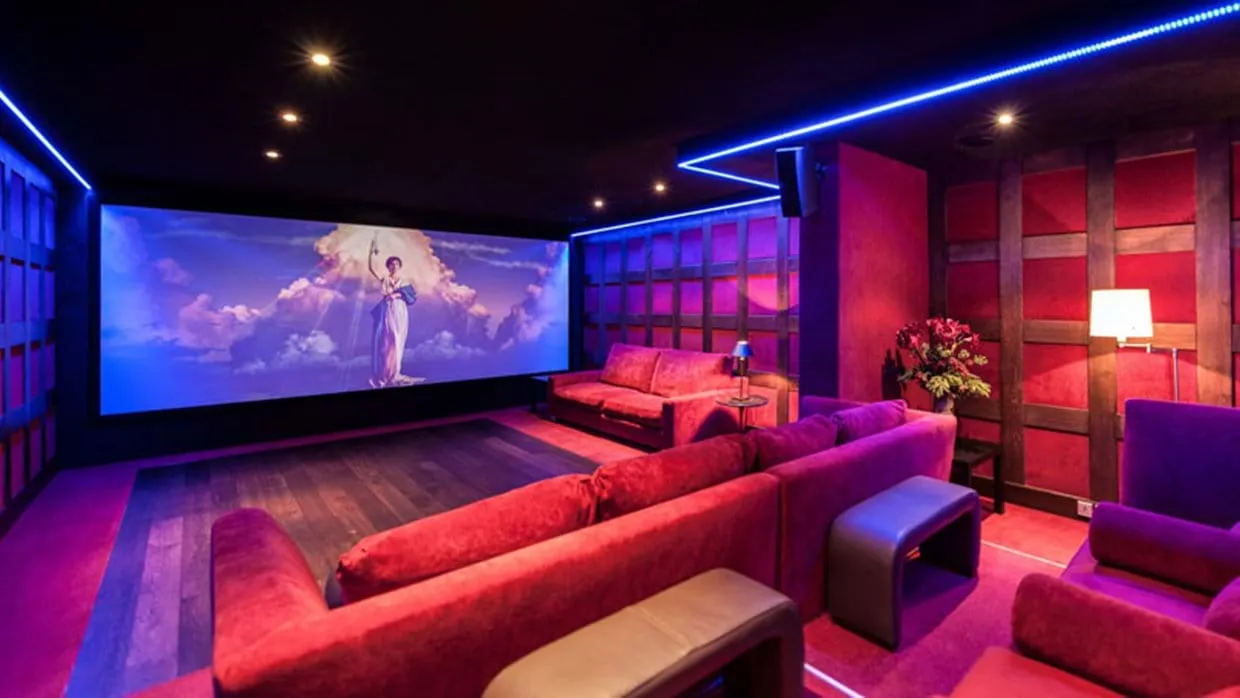 Private cinema with 120-inch screen and tiered velvet sofa seating