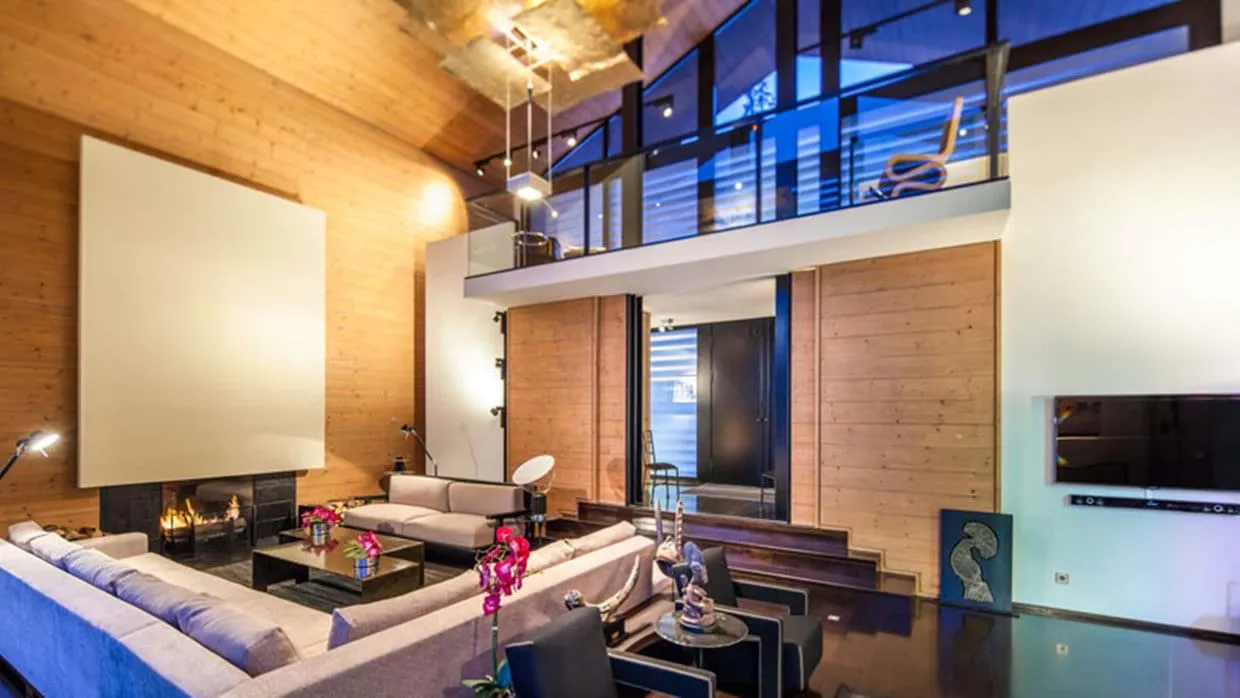Living area with wood-burning fireplace and mezzanine loft view