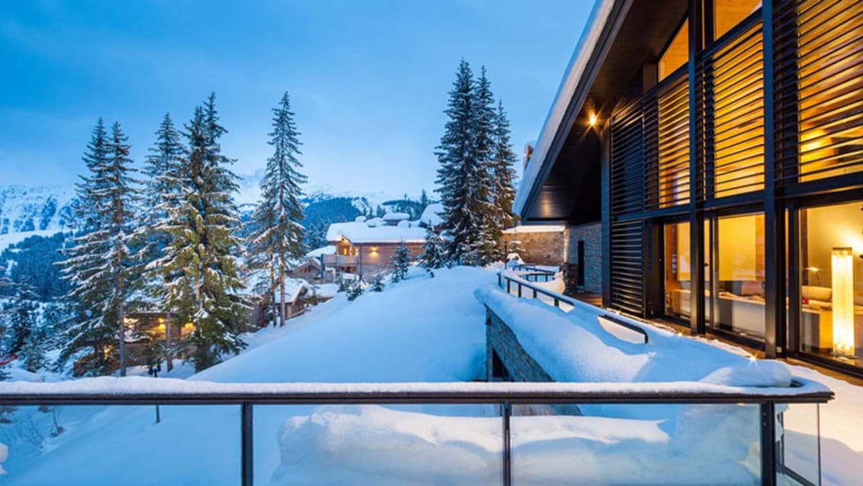 Private balcony with glass railings and panoramic mountain views