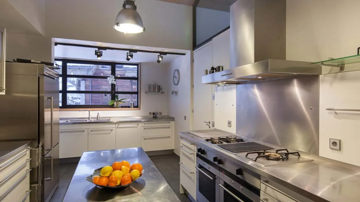 Chef's kitchen with stainless steel countertops and dual Gaggenau ovens