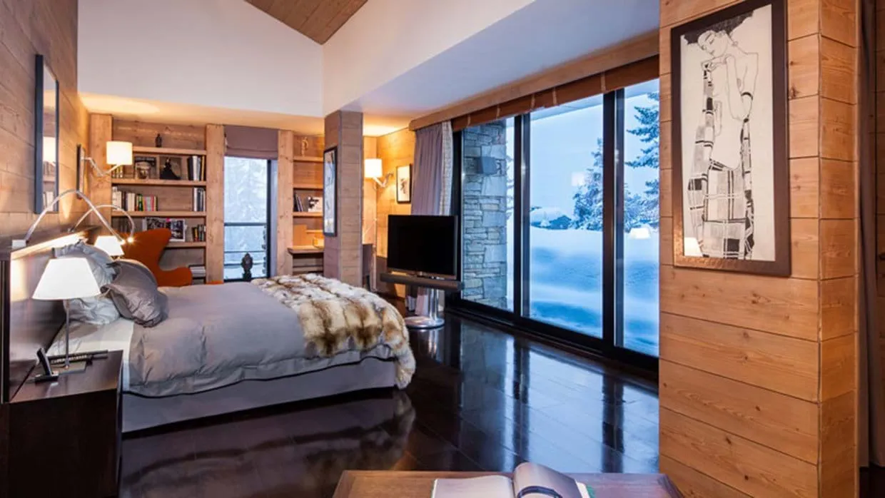 Primary bedroom with king bed, reading nook, and snow-covered mountain views