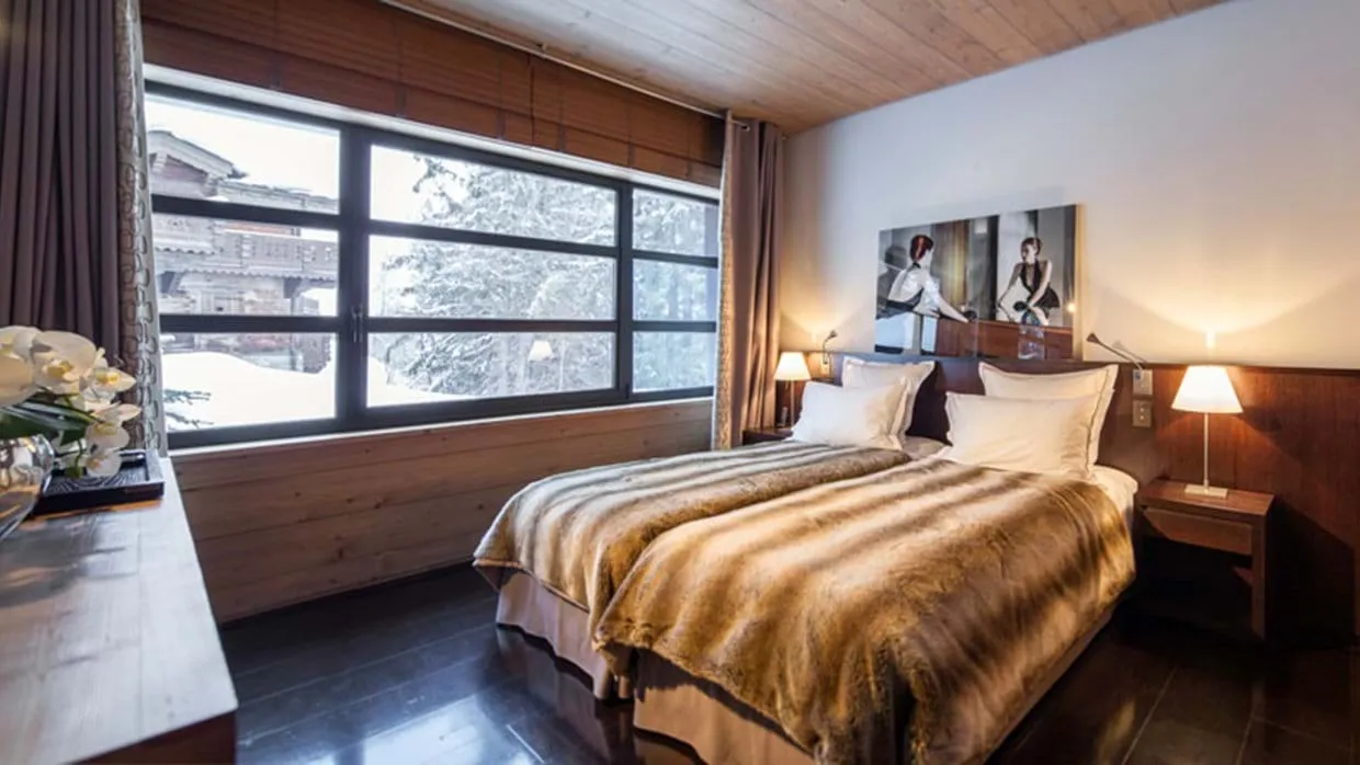 Guest bedroom with two twin beds and village views