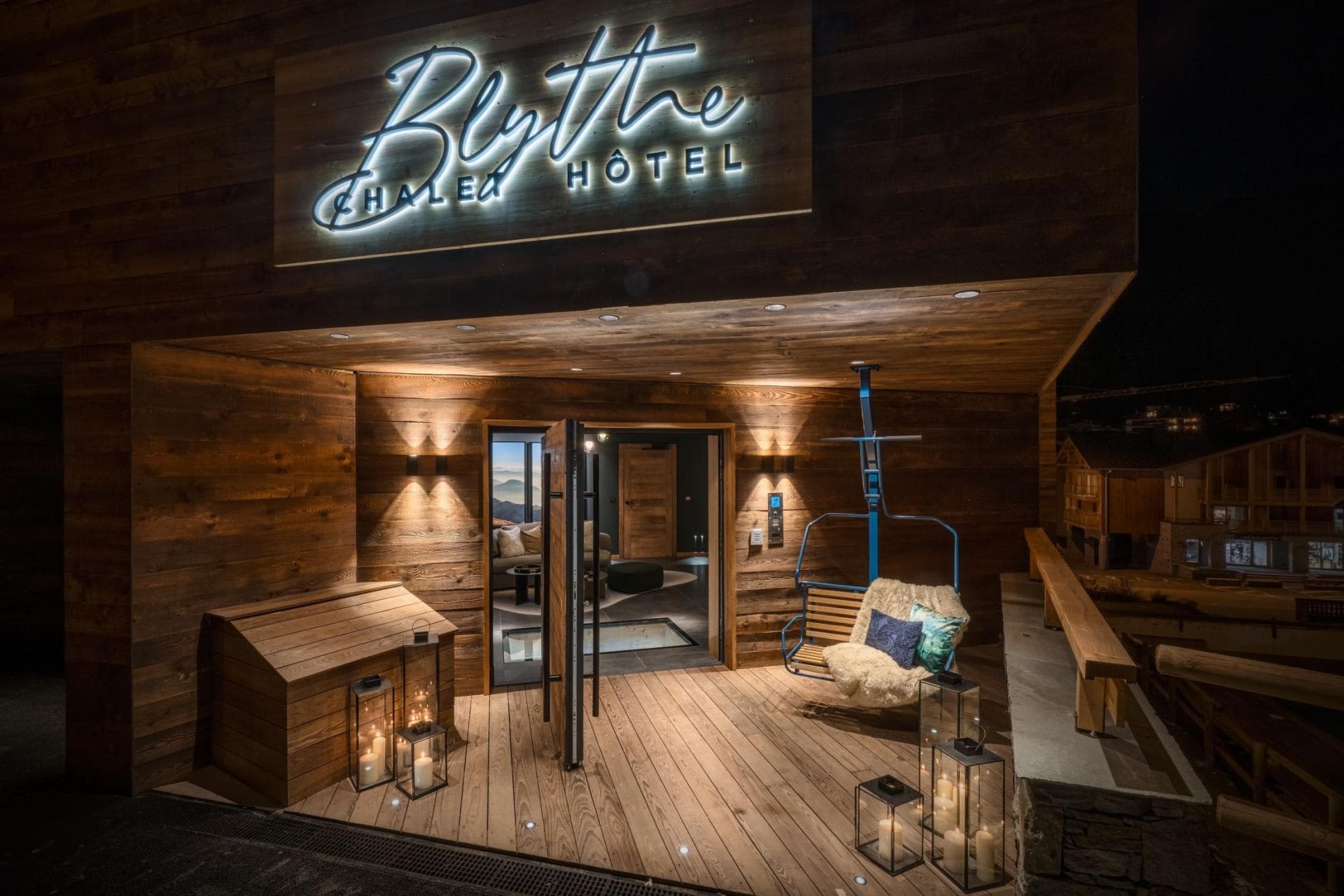 Chalet entrance with heated deck and vintage ski lift chair seating