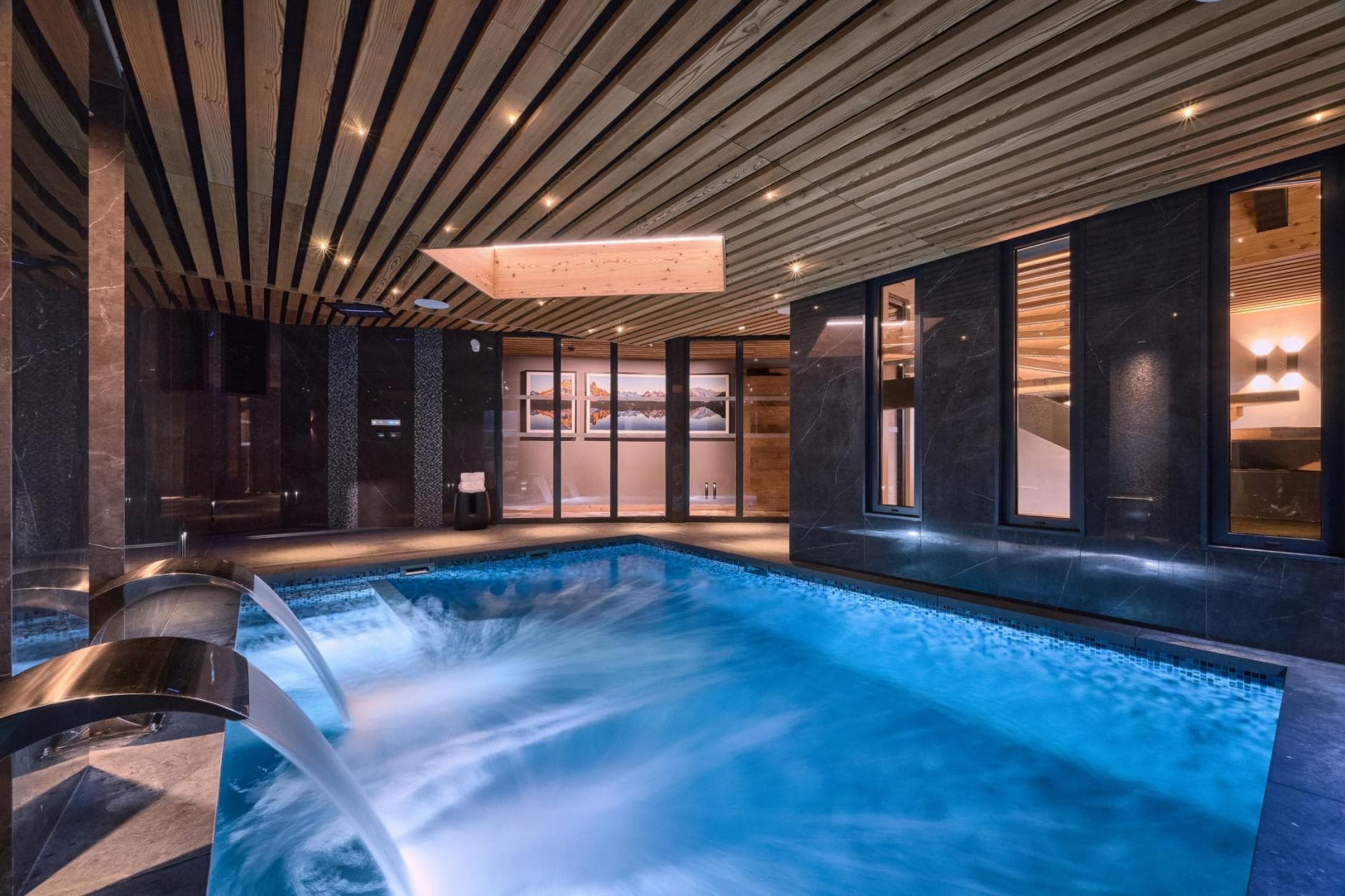 Indoor heated pool with integrated massage jets and waterfall features