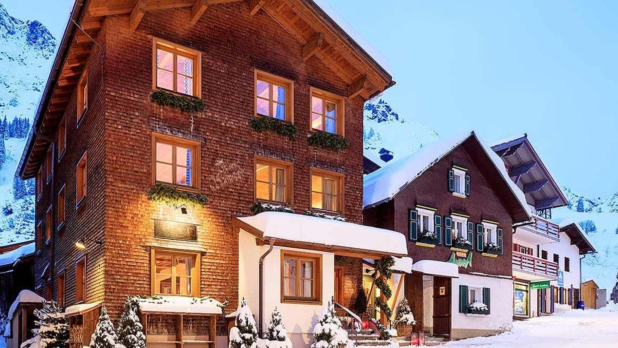 Ski-in chalet exterior with wood shingle facade and mountain access