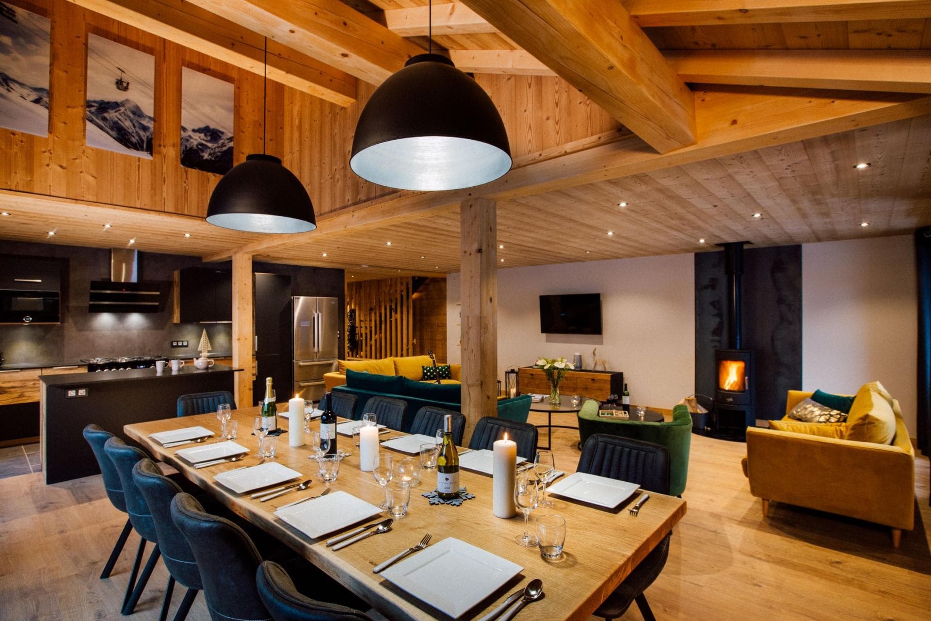 Open-plan dining area for 10 with wood-burning stove and adjacent kitchen