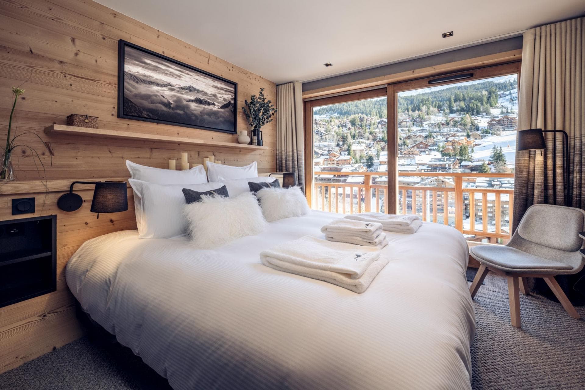 Primary bedroom with king bed and balcony overlooking ski village