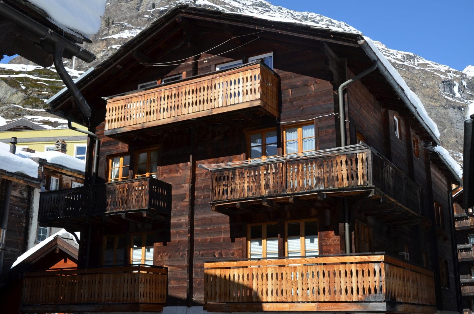 Chalet exterior featuring private timber balconies with mountain views