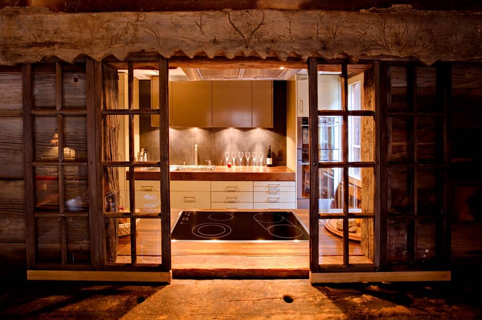 Kitchen with induction cooktop and hand-carved reclaimed wood framing