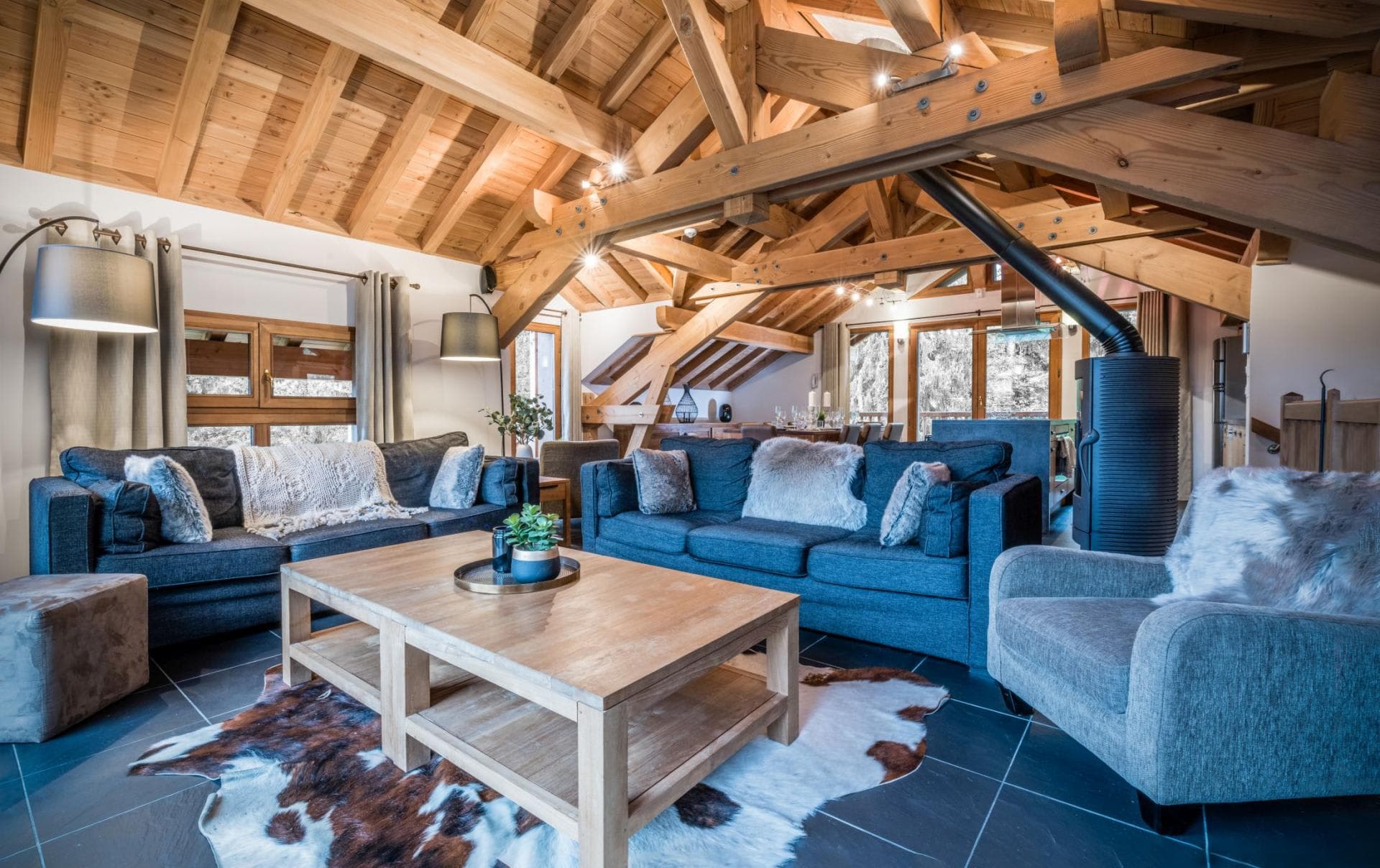 Living area with vaulted timber ceilings and wood-burning stove